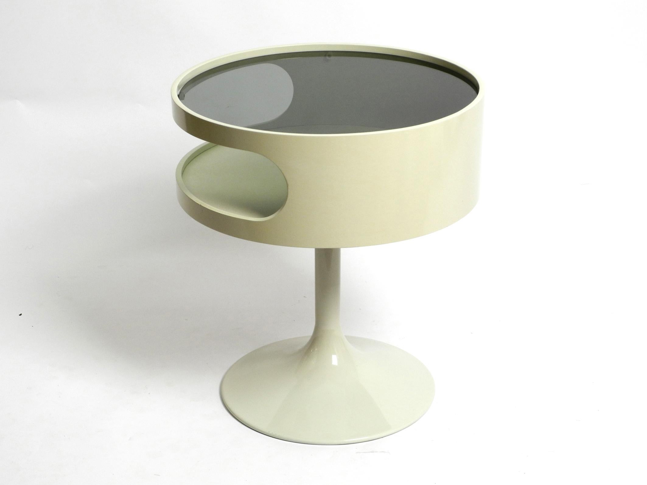 Beautiful rare original 1970s white side table by Opal Möbel.
Stunning Pop Art design with smoked glass top and tulip base.
Very good vintage condition with no signs of wear. As if just have been unpacked recently.
A tiny paint defect on the top