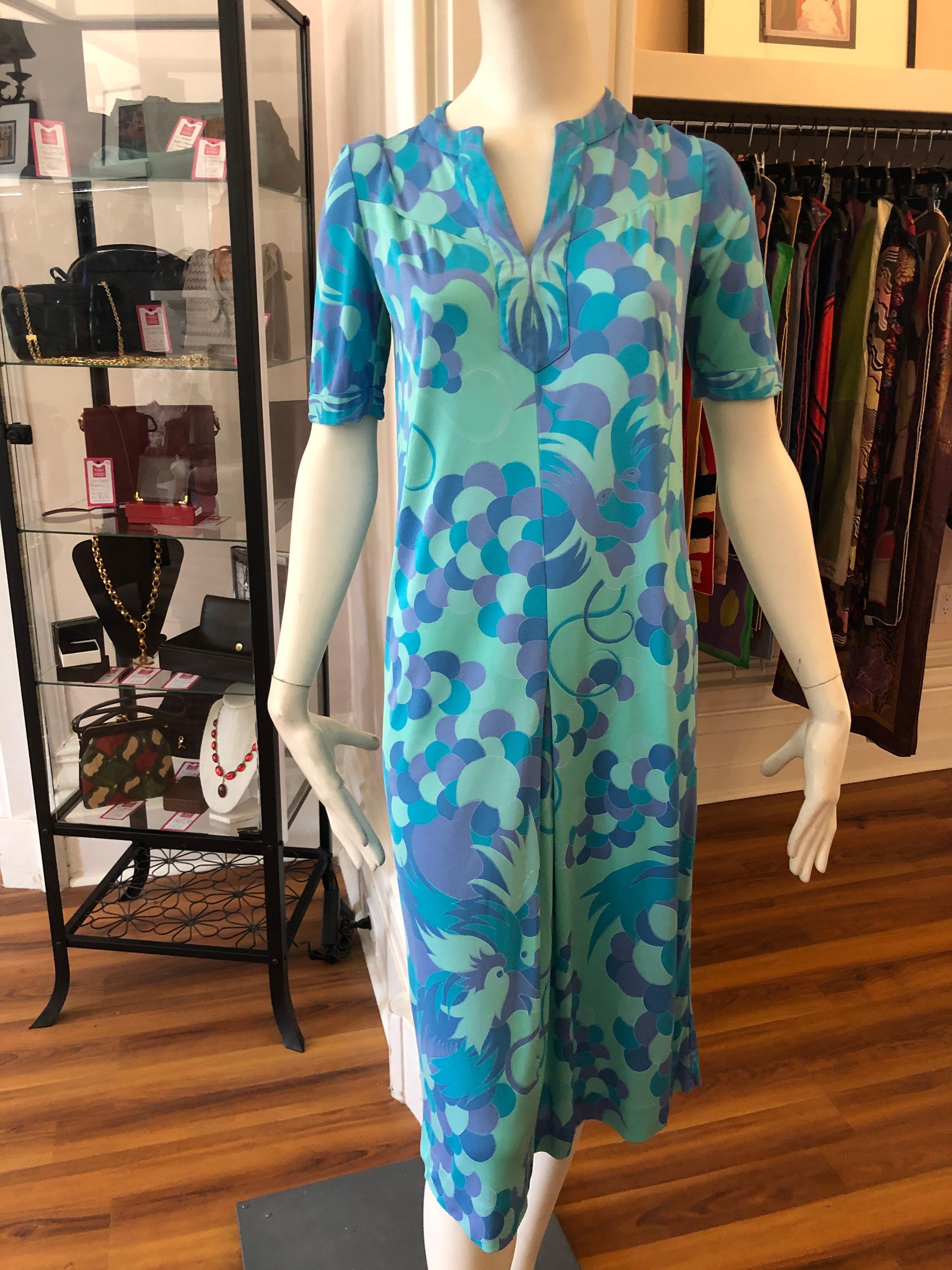 Gianni Versace designed this dress for Di Parisini in the 1970s as one of his first independent commissions. This dress is made of 100% silk and the print comprises exotic birds and leaves and circular designs. There is an inverted front pleat 3/4