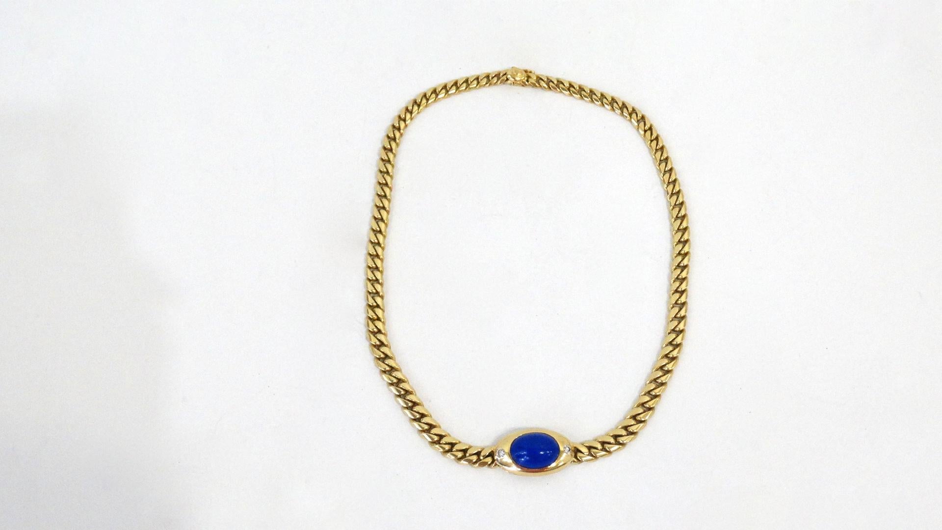 This rare and beautiful 1980s Bulgari 18k Gold chain link collar necklace features Lapis Lazuli oval stone with two White Diamonds on each side. Tested and signed 750 for 18k Gold and includes a French 