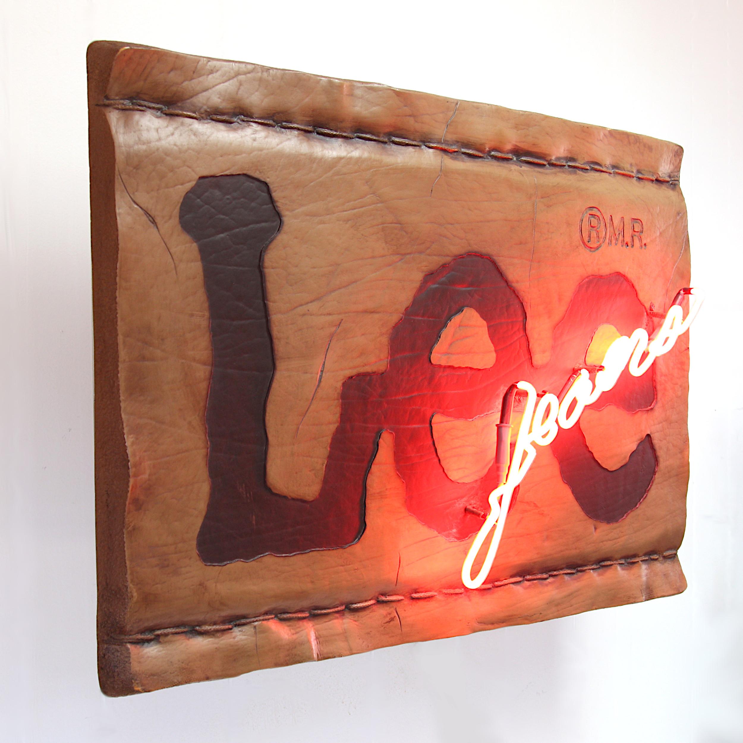 Wonderful vintage Lee Jeans neon sign only available to official Lee Jeans dealers. Sign features a molded-foam form in the shape of a leather Lee tag (over plywood core), red neon 