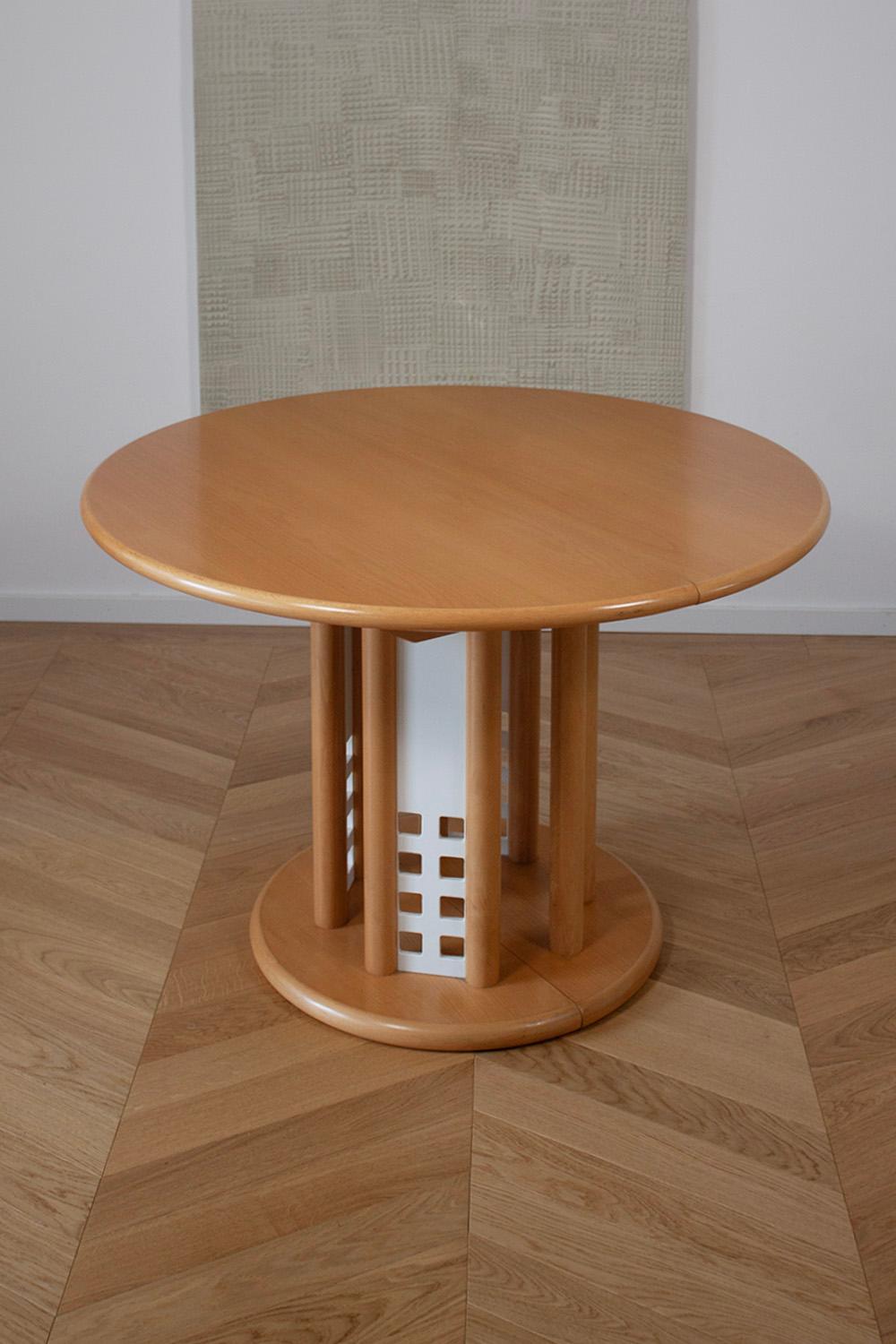 This very rare extendable Thonet table is a classic 1990 Design. The Table is made from beech wood and has 4 interesting white metal panels at the base, which give it that 90s feel. The table is in great condition with almost no scratches or