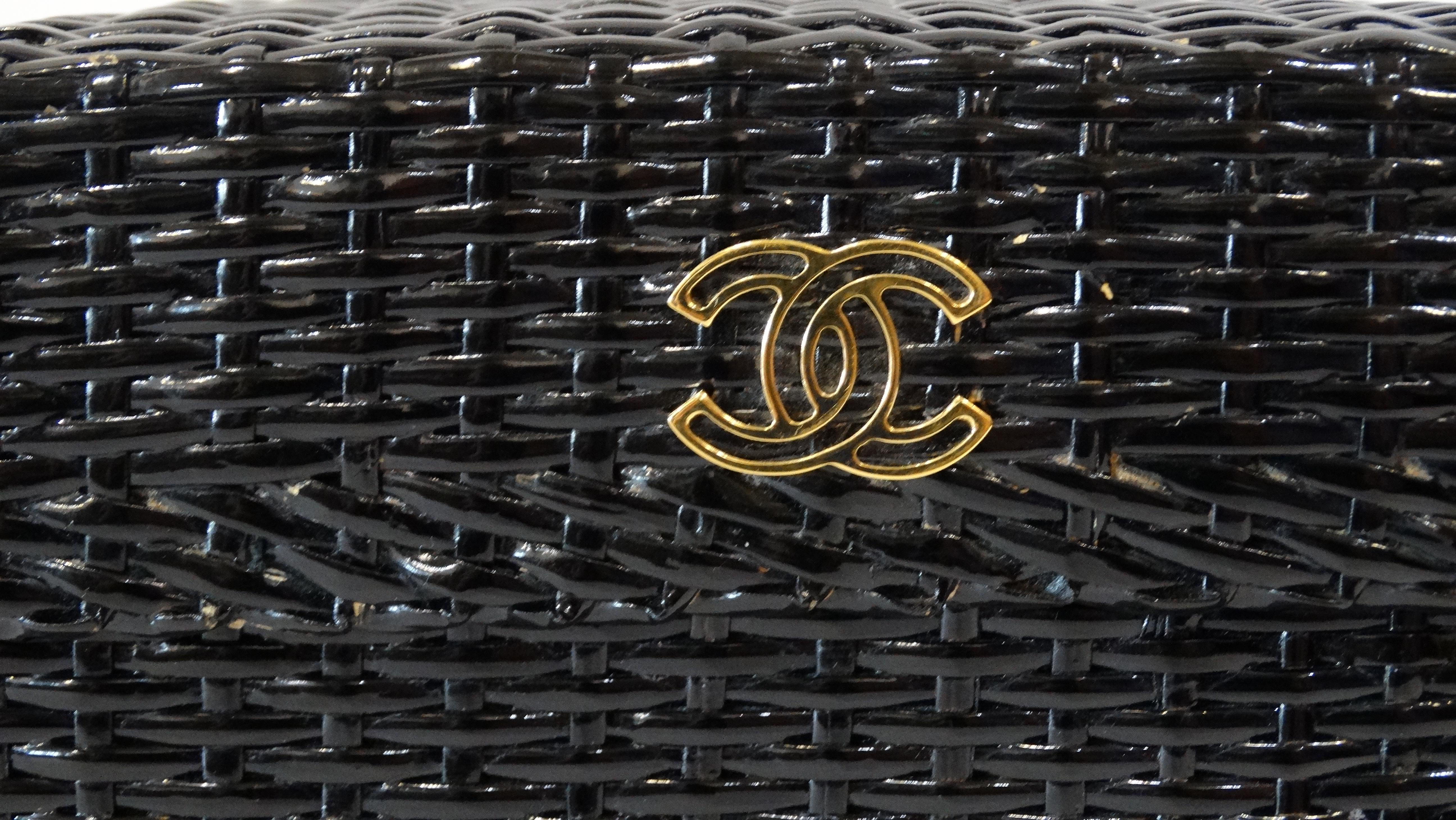 Carry around a piece of vintage history courtesy of Karl Lagerfeld! Circa late 1990s, this rare Chanel bag screams mini picnic basket with its black glazed woven rattan exterior and adorable basket shape. Features gold plated hardware, long