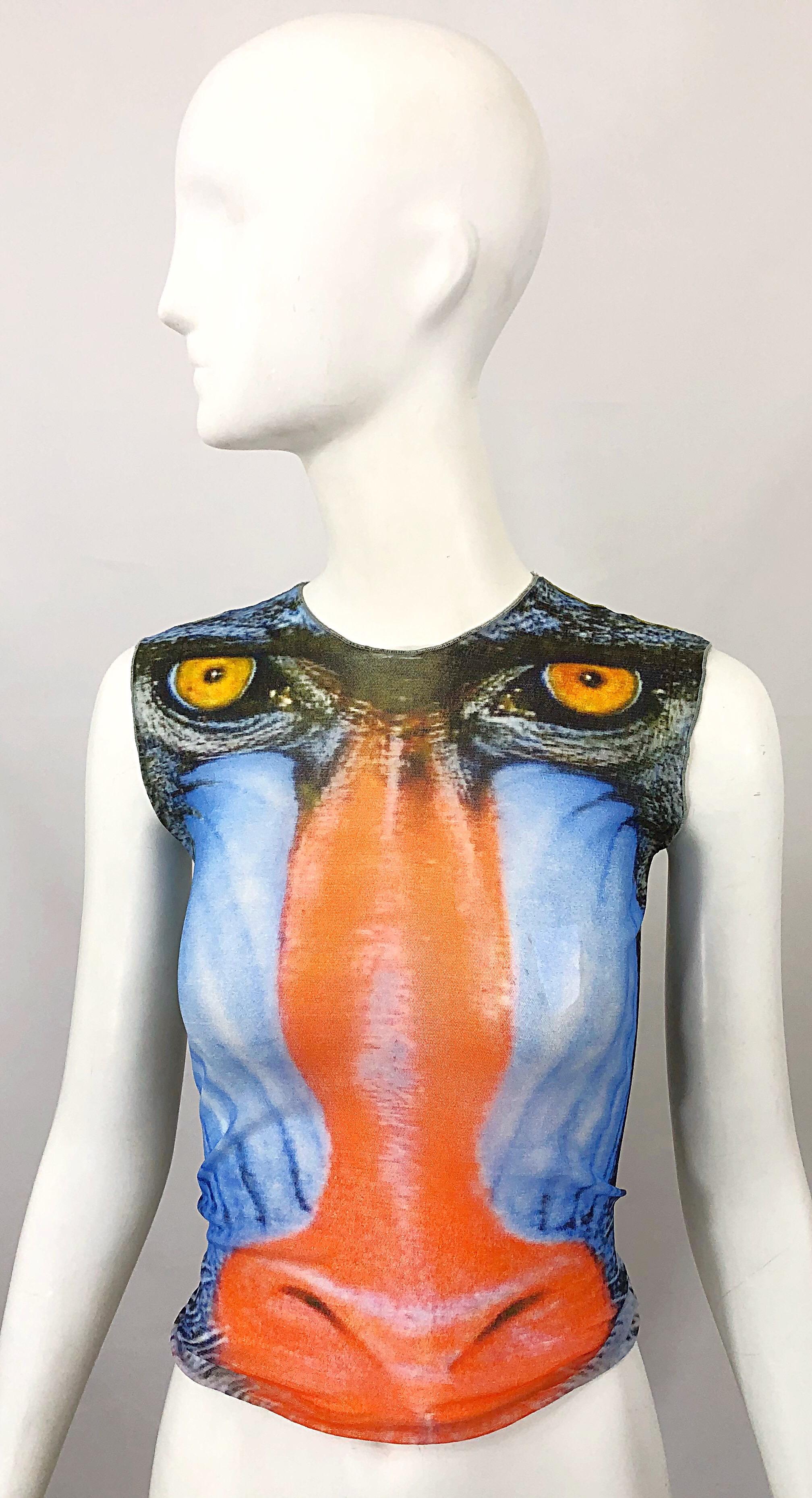 Rare and collectible vintage 90s baboon mandrill novelty print semi sheer mesh crop top! Features vibrant colors of orange, blue green, yellow, black and white. Simply slips over the head, and stretches to fit. Can easily be dressed up or down.
