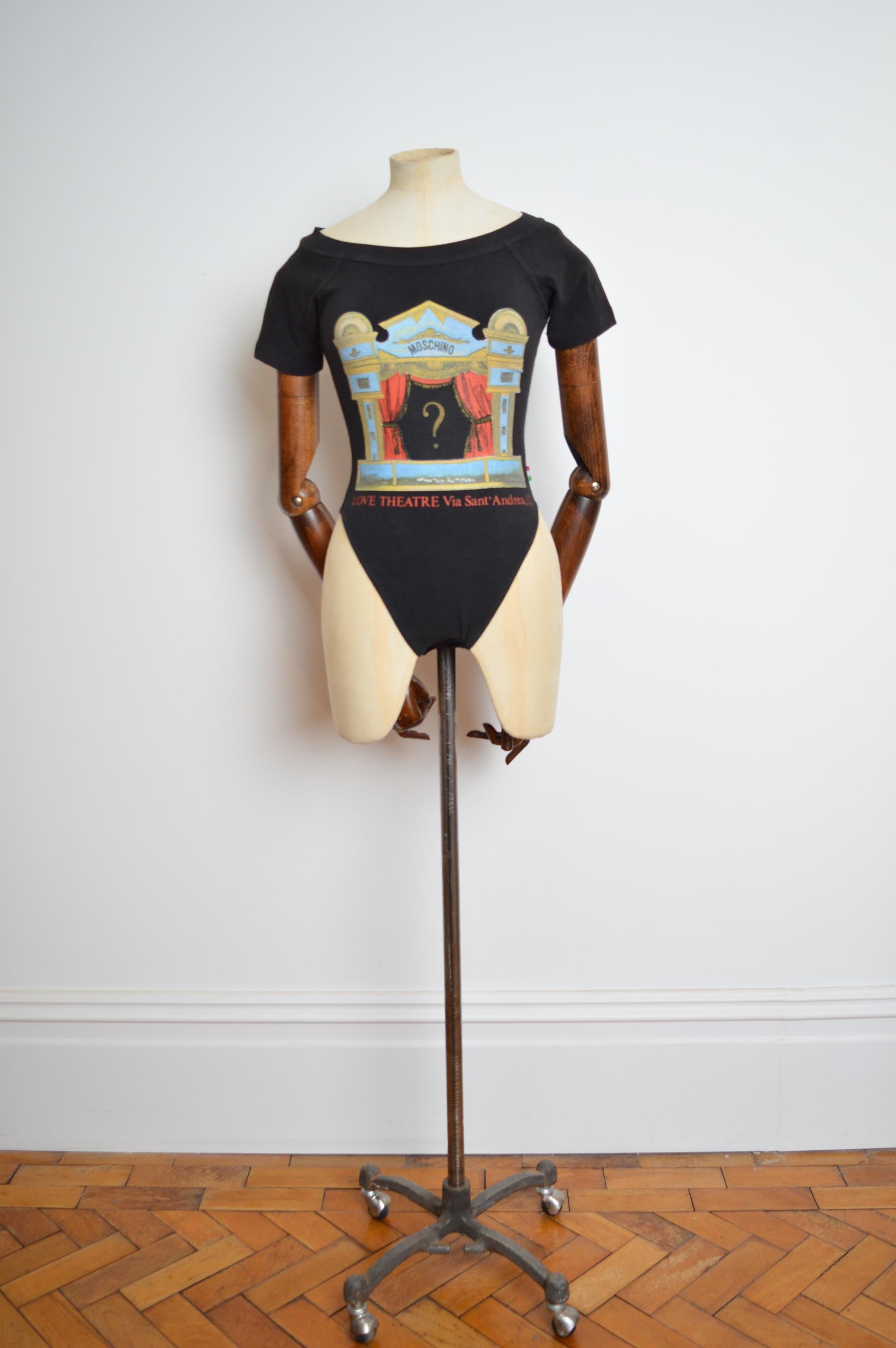 Rare 1990’s Moschino ‘Love Theatre’ Via Sant Andrea 12 MILAN Black stretchy body suit.
MADE IN ITALY ! 
Press stud crotch closure 
Stretchy figure hugging material 
Pit to Pit; 14.5”-16.5”
Nape to Hem; 27” (laid flat will stretch further)
Waist;