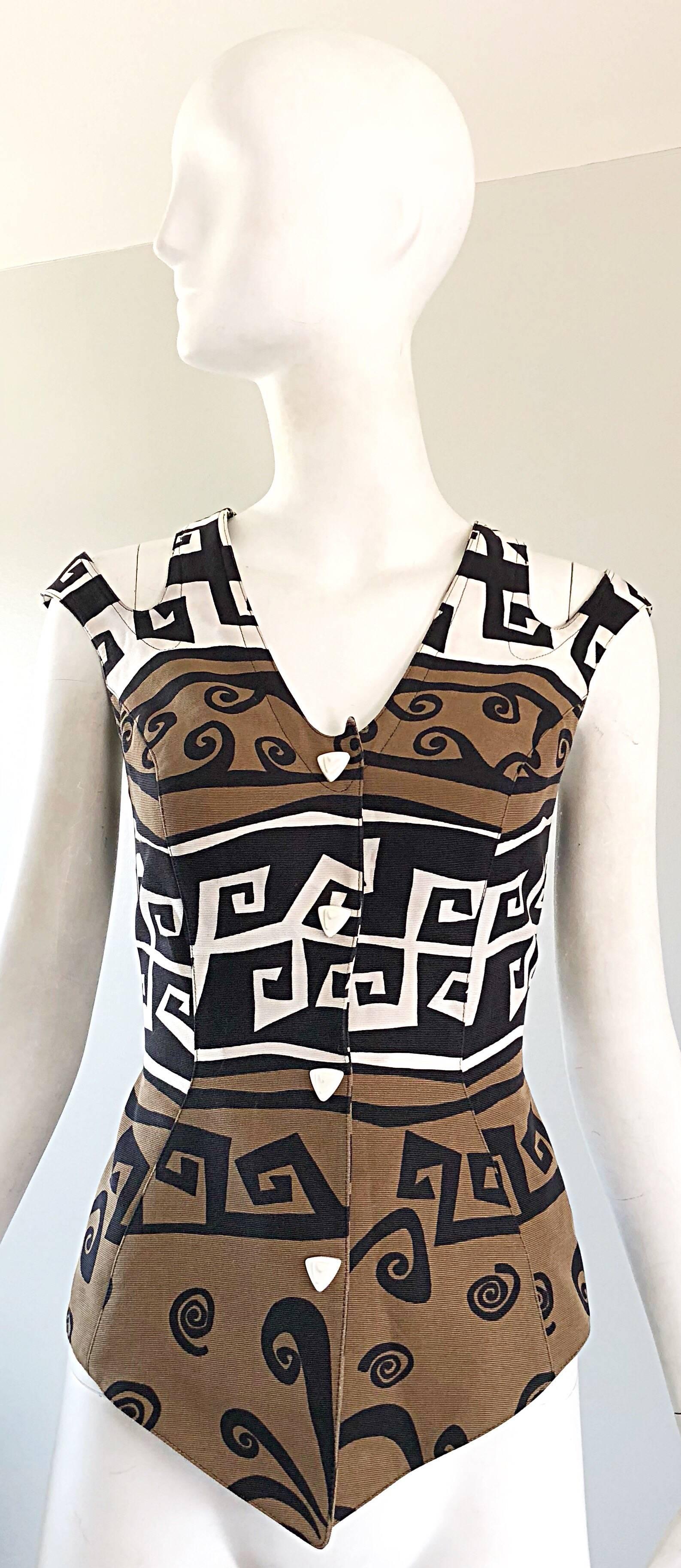 Amazing and rare 90s THIERRY MUGLER Aztec abstract print cotton cut-out cold shoulder waistcoat / vest / top! Features abstract prints in tan, brown, white, ivory and black. Signature white plastic covered snaps up the bodice. Cut-out details at
