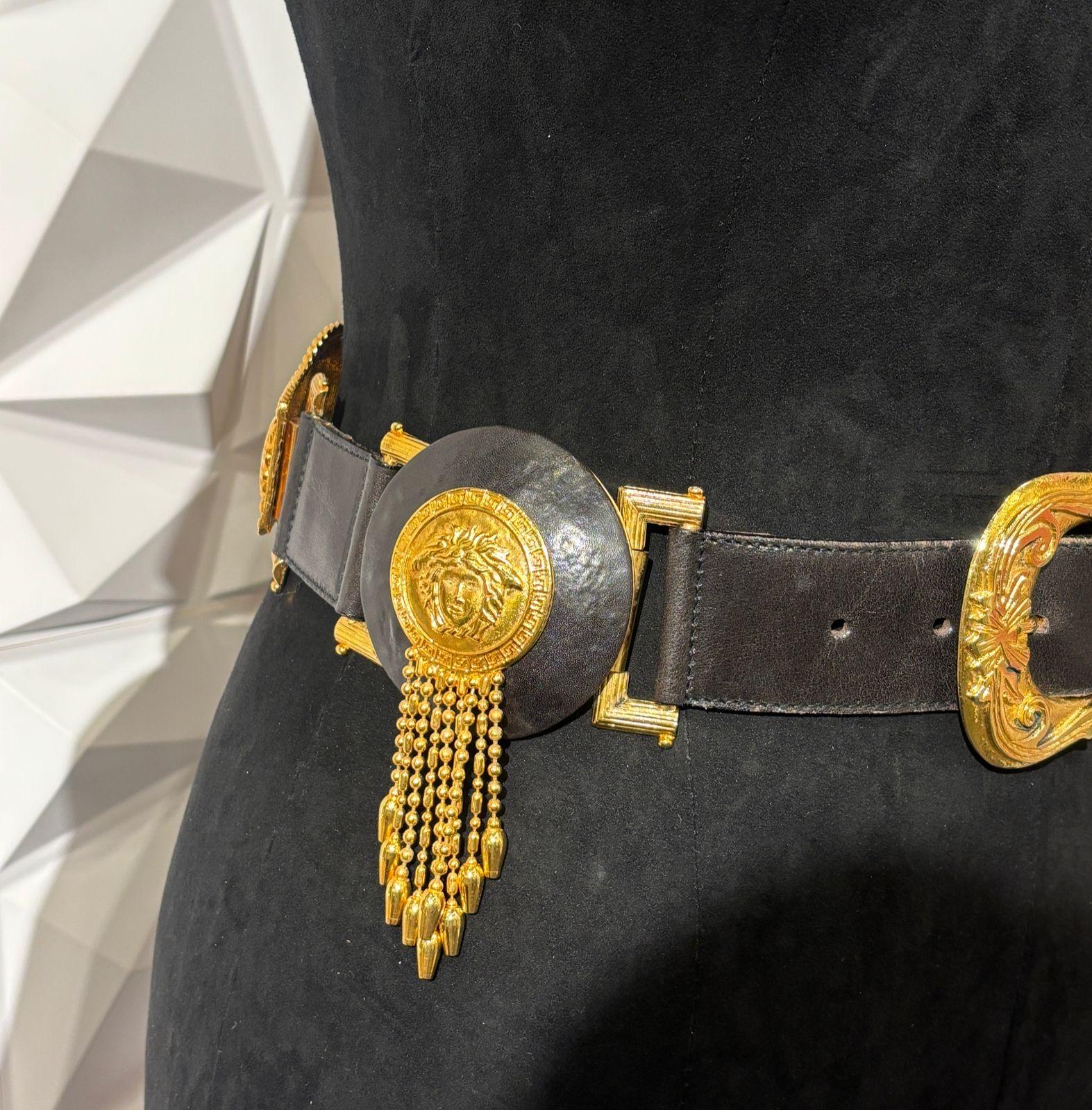 Rare Gianni Versace waist belt with tassels hardware detail. Slight press marks and scratches on the leather area. Light tarnishing on the hardware. Size 70.