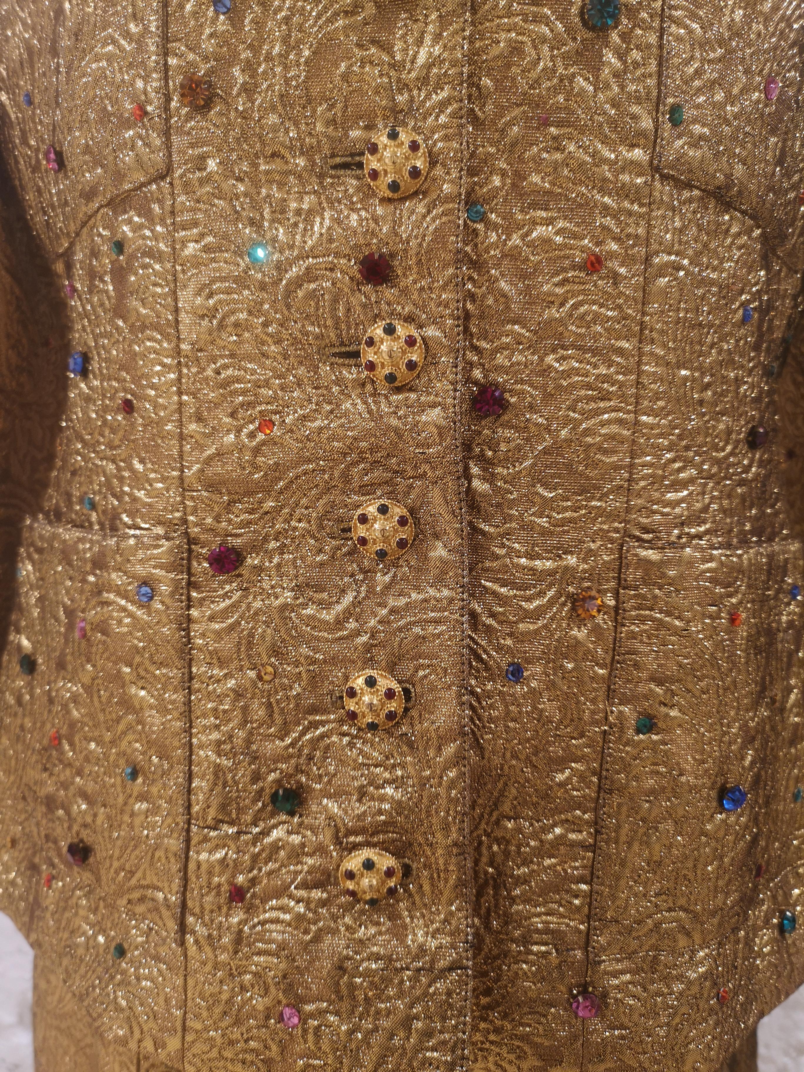 Very rare gold metallic matelasse quilted suit with colored rhinestones and poured glass Gripoix buttons from Chanel exactly as seen on the runway and featured in the Chanel ad campaign for fall of 1996. 
Chanel Byzantium collection made of lurex