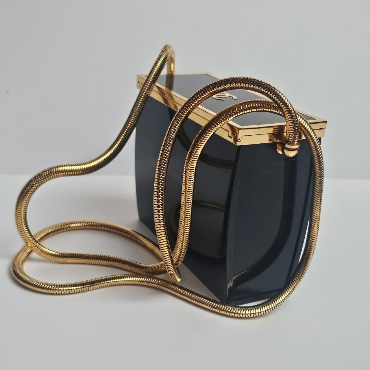Rare vintage 1997 chanel acrylic box bag in black with gold snake chain. Collector piece. Minor scratches on the exterior. Engraved stamp 97. Comes with replacement dust bag.