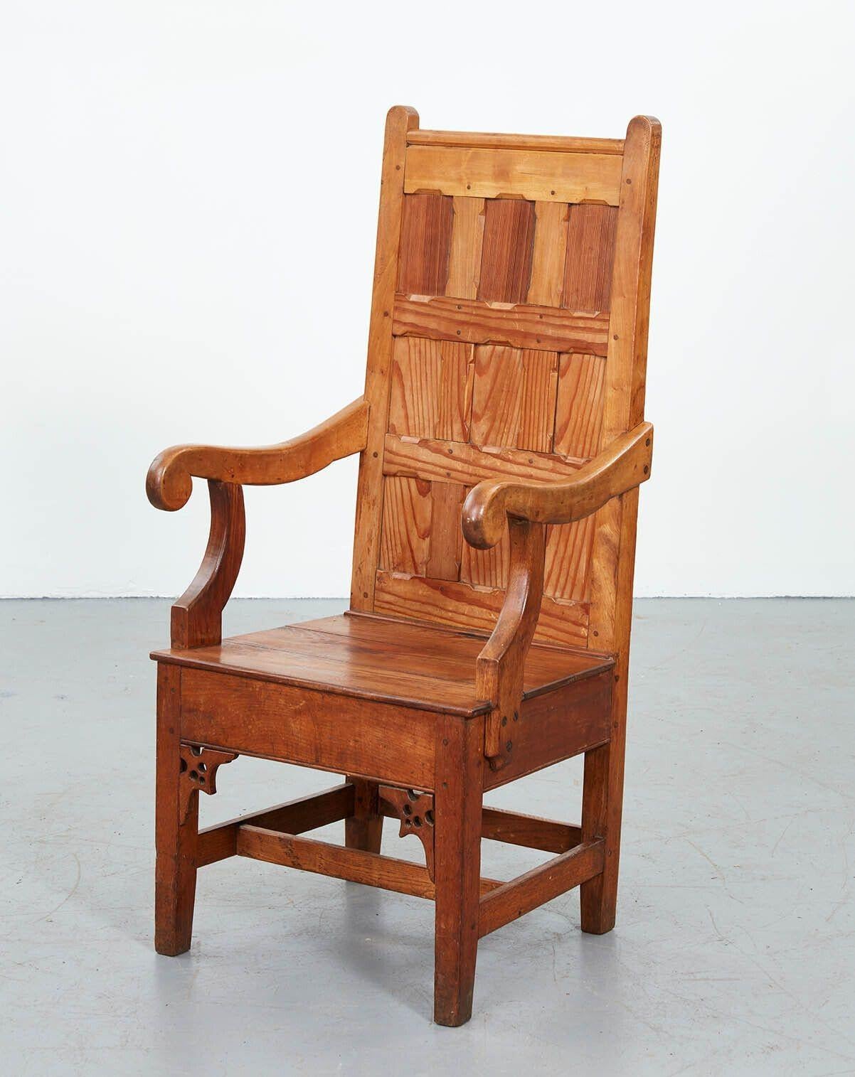 A rare 19th century Canadian tall back armchair in pine. Fine quality quarter sawn timber and craftsmanship, with wooden peg and tenon construction and floating panels. The back support is paneled in a three by three grid, with chamfered rails