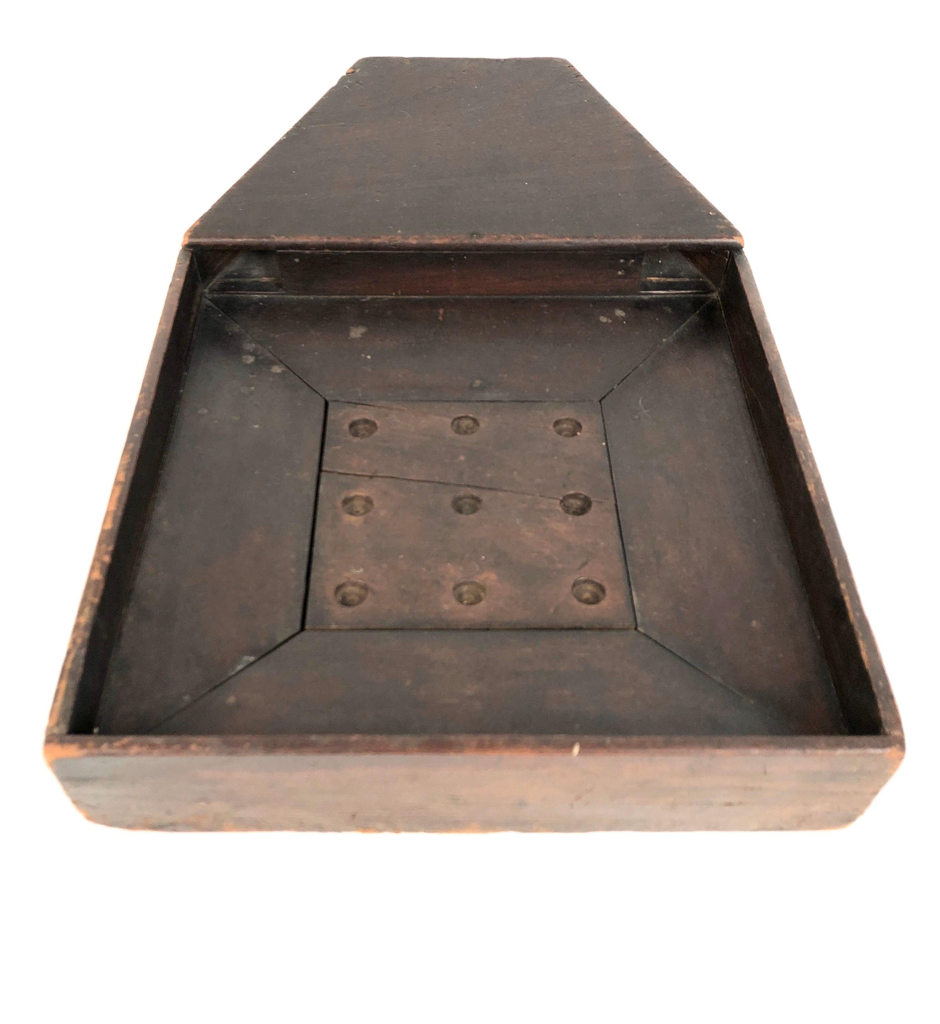 A rare and unusual American 19th century wooden Folk Art game similar to roulette in that a marble is dropped in one of two elevated lots in the back, rolls down either chute and circles the board before dropping into one of 9 carved holes with