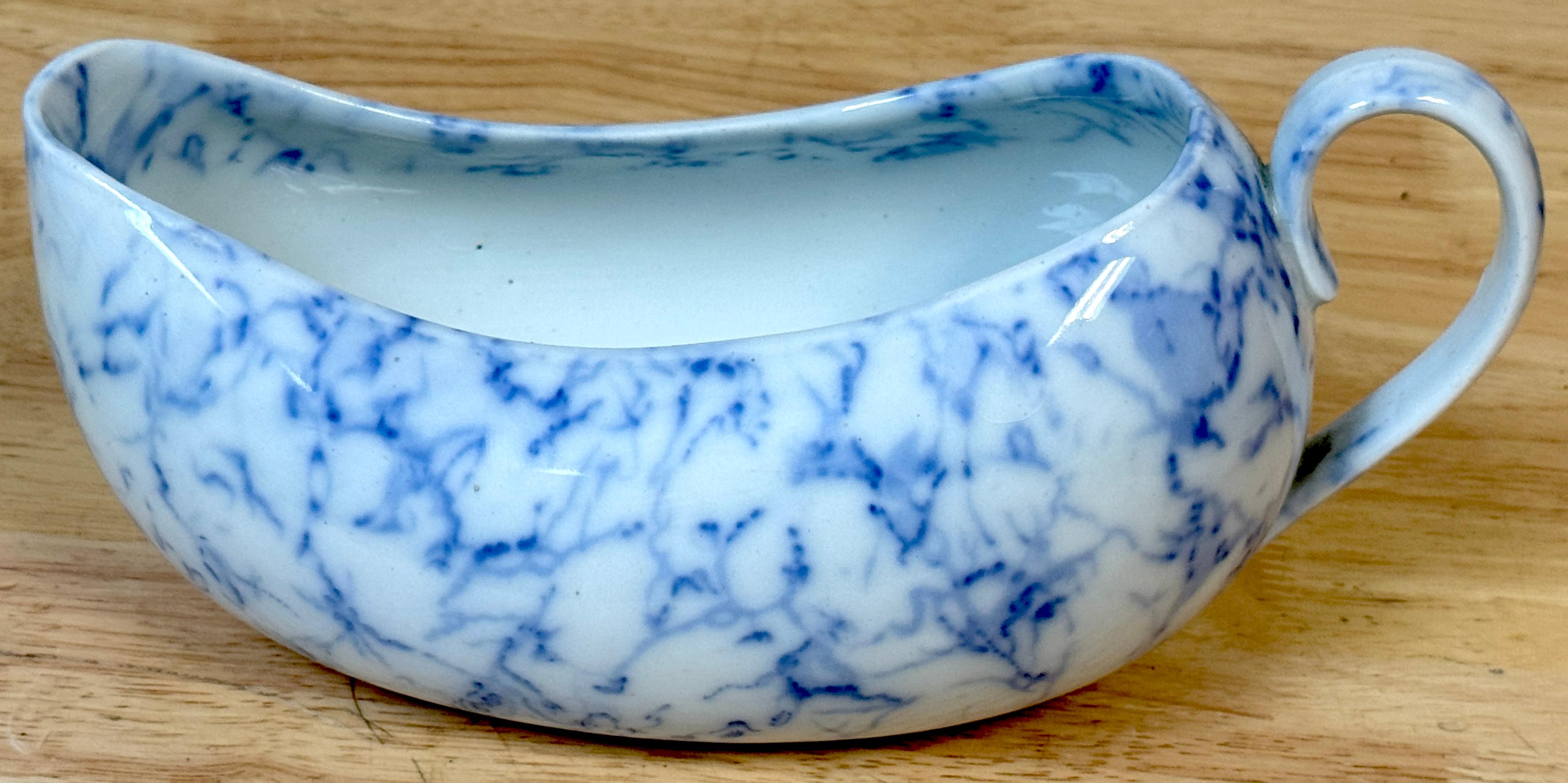 Rare 19th C. English Blue & White Marbleized Porcelain Bourdaloue (Ladies’ Chamber Pot), England, Circa 1860

A rare and refined example of Victorian-era sanitary design, this 19th-century English porcelain bourdaloue—also known as a slipper pot—was