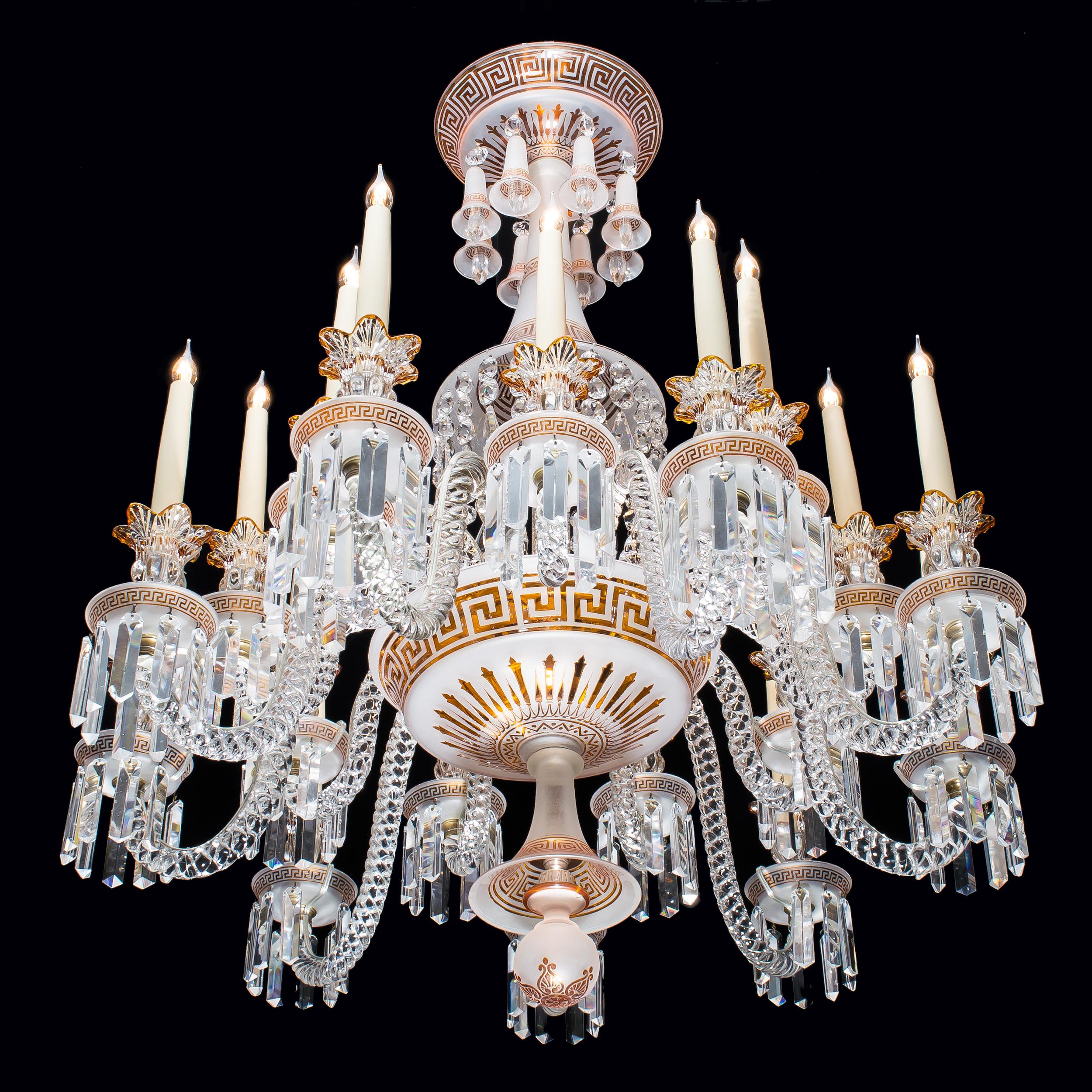 A fine and rare 18 arm crystal chandelier
by Baccarat

The 18 solid twisted glass arms support clear and amber crystal candle holders on acid etched amber cut-to-clear bobèches decorated à la grecque - as are the other major elements composing