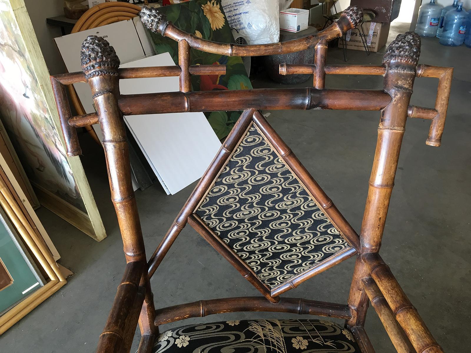 RARE 19th Century Aesthetic Movement bamboo throne chair featuring a geometric design and black crane embroidered fabric.  Circa 1950