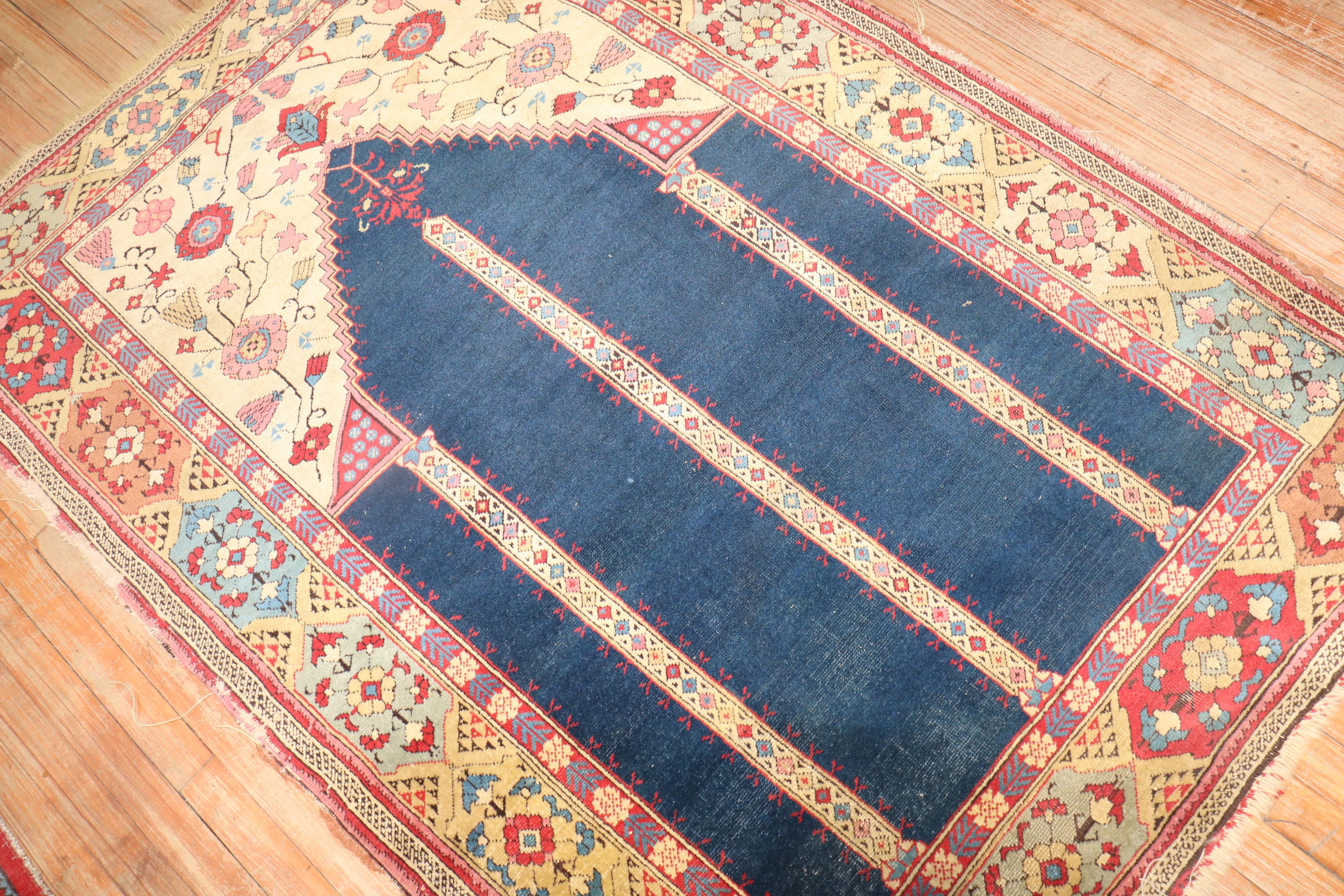 Late 19th century Transylvanian Tuduc Romanian Prayer rug with a double scroll niche design on a striking navy field.

Measures: 4'1'' x 5'10''.