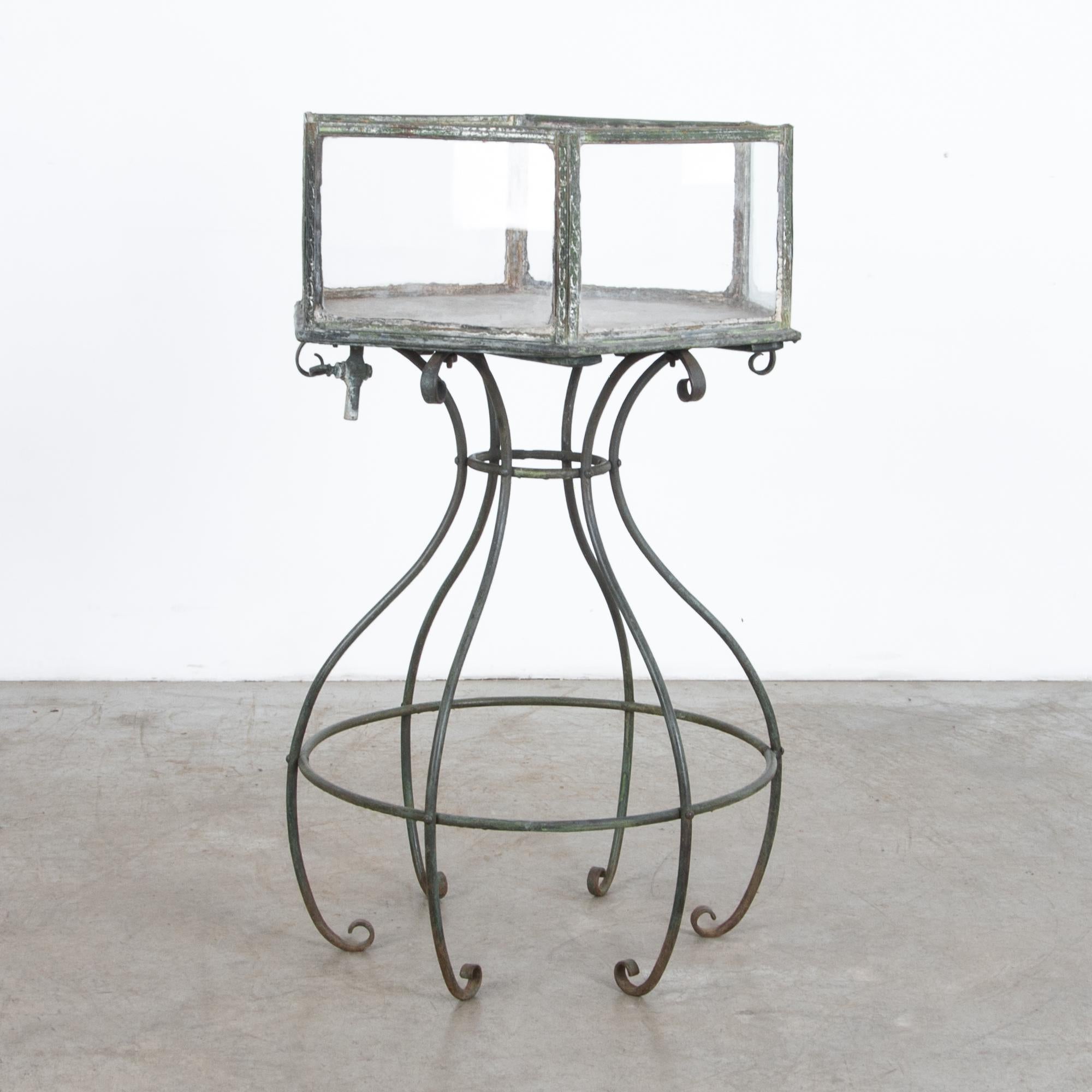 This rare piece was sourced in Central Europe, likely originated in Czech Republic or Germany, with distinctive wrought iron construction, copper banding and shouldered window glaze. Great texture and intriguing details, hand forged scroll legs,