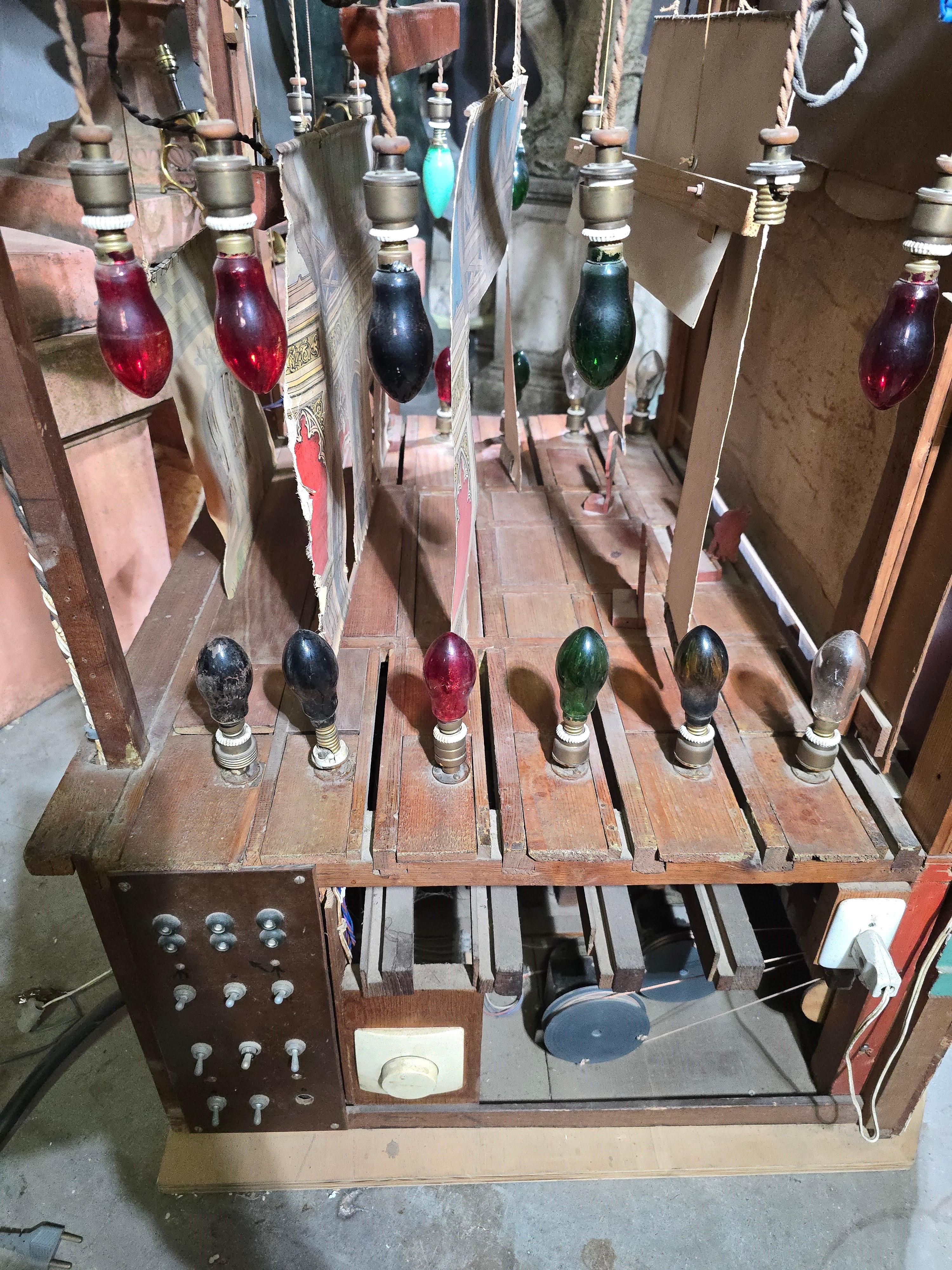 This important and rare automaton theater dates from the late 19th century and features both its original mechanical system and later electrical modifications.

Materials: Constructed from wood and metal, the theater showcases intricate