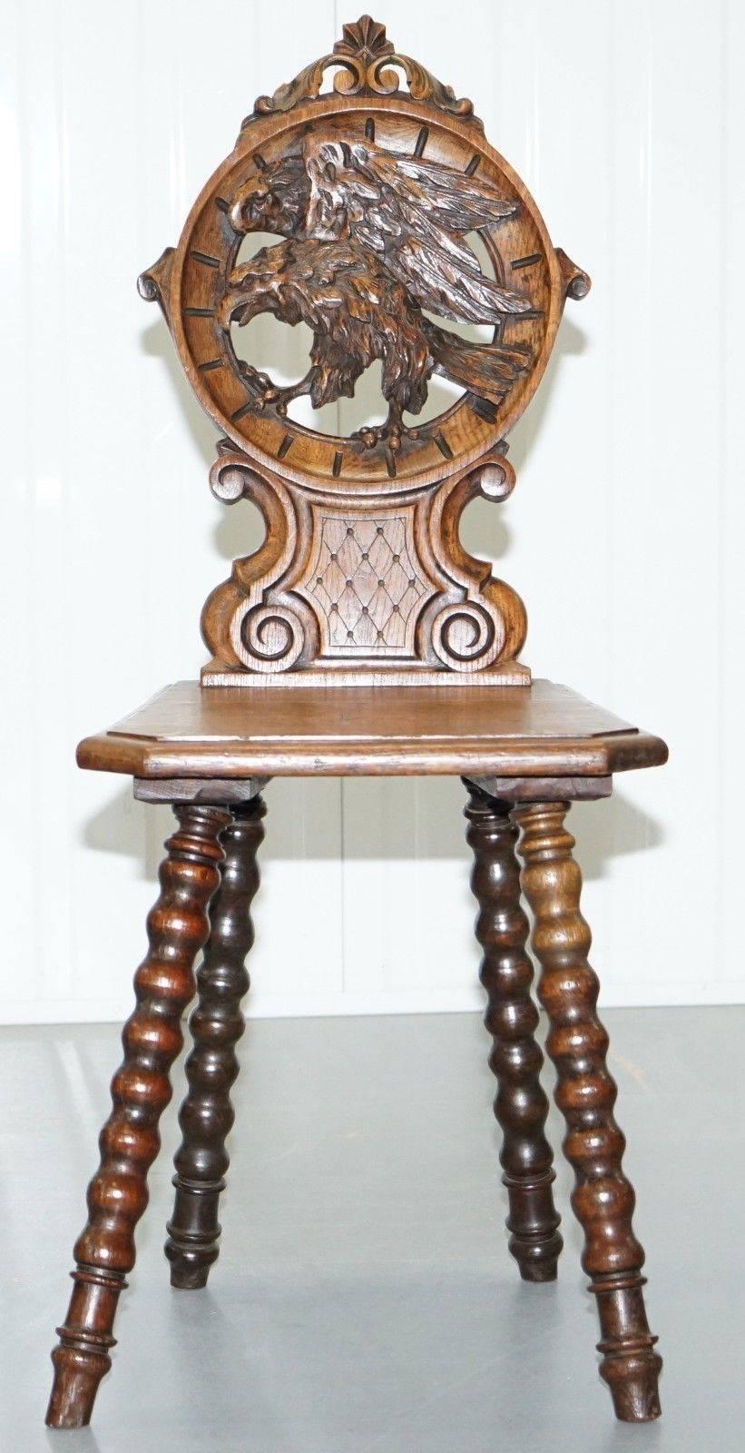 Nous avons le plaisir de proposer à la vente cette magnifique chaise de salon en chêne noir Forrest sculptée à la main, avec des pieds tournés aux fuseaux et un grand faucon à l'arrière, vers le début du 19e siècle.

L'une des plus belles chaises