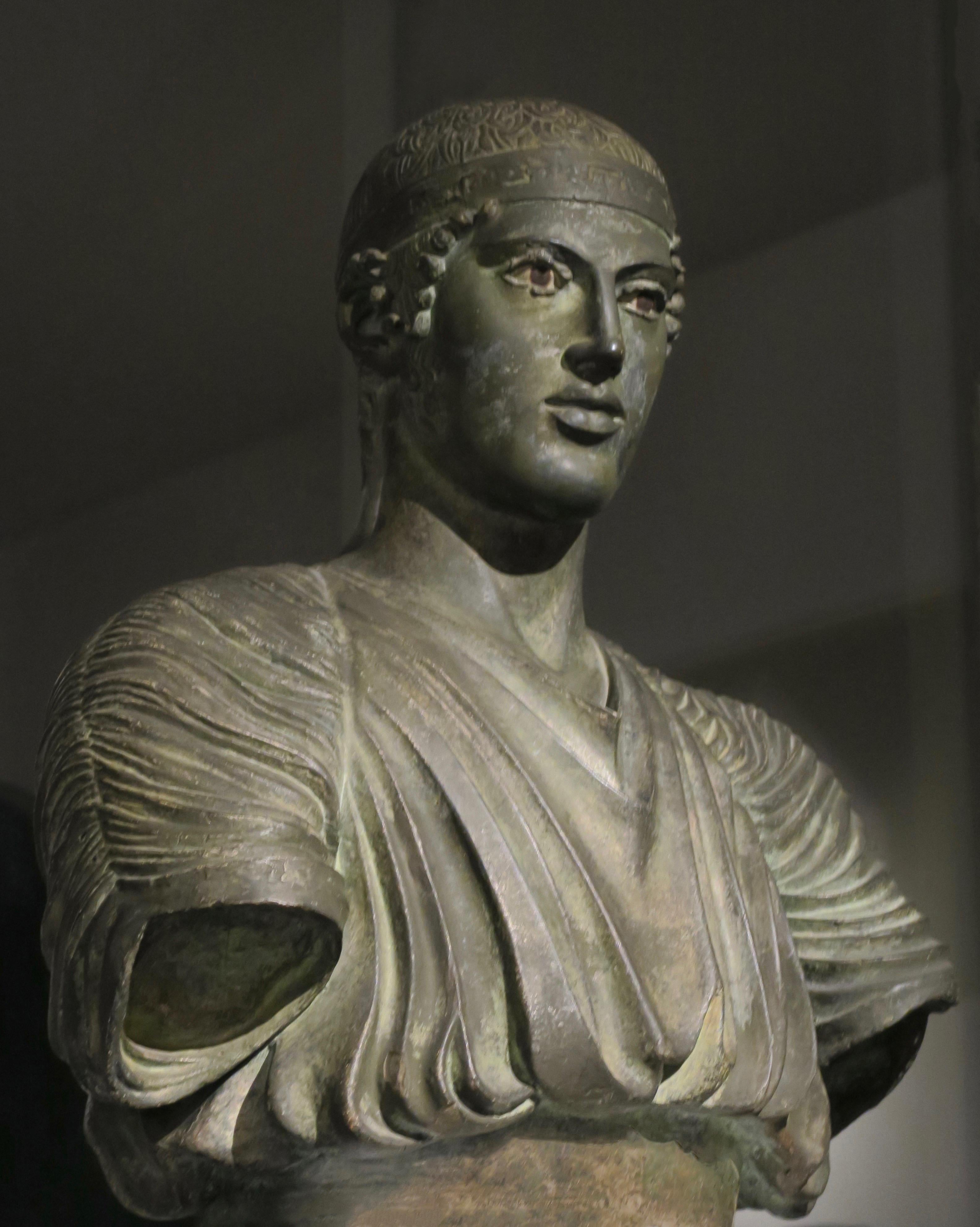 Amazingly beautiful 19th Century Italian neoclassical bust of the Charioteer of Delphi plaster with an exceptional patina in the absolutely perfect depiction of the aged bronze from the antiquity (see attached picture of a real sculpture of the same