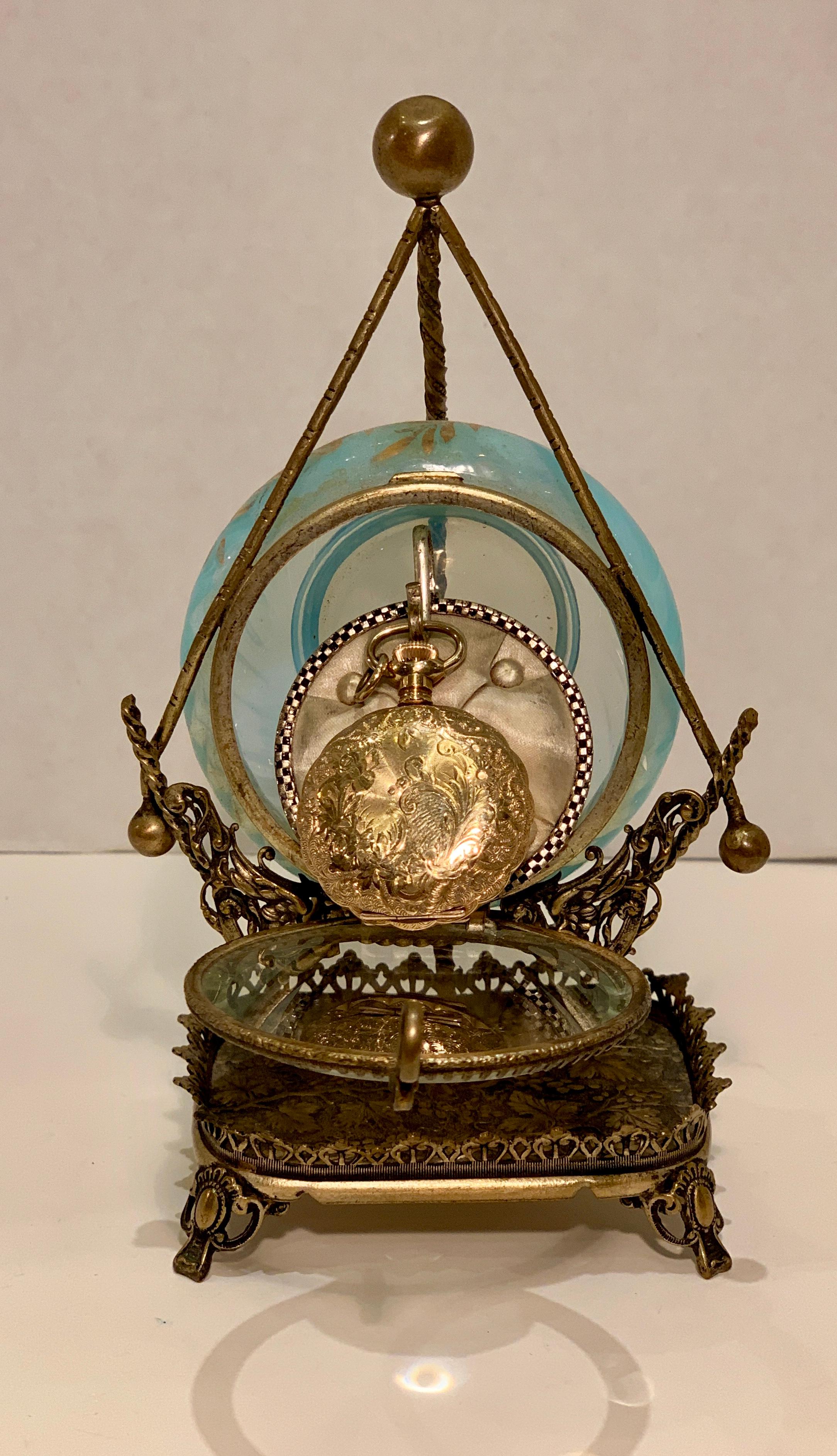 Opulent, antique display case for a pocket watch from the Victorian era is a work of art!  Round beveled glass door is hinged on the bottom.  When opened, a tufted silk pillow with a hook slides forward to accept a pocket watch for safekeeping. 