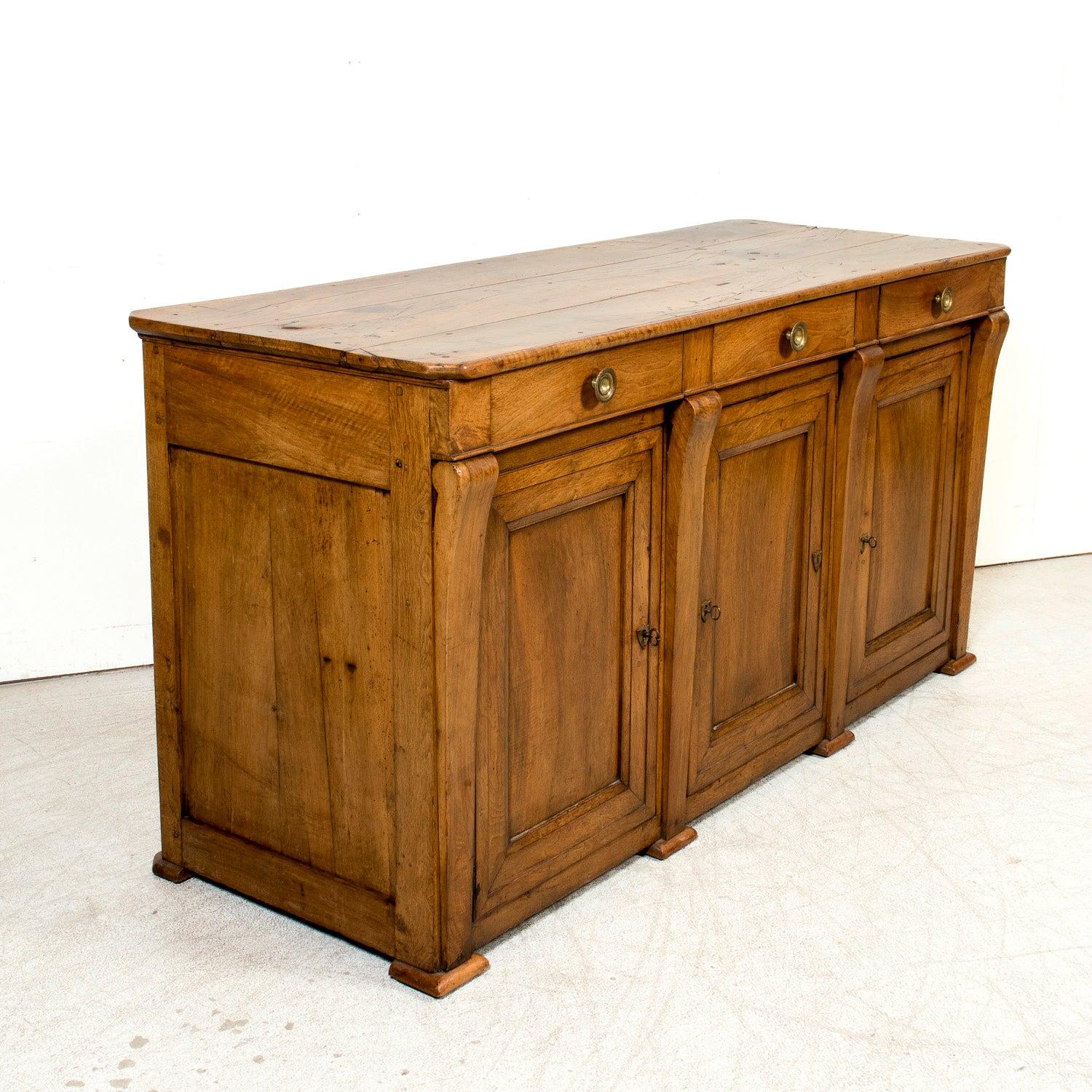 A rare 19th century French Restauration period kitchen island handcrafted by talented artisans in the South of France in the heart of Languedoc, just outside the medieval city of Narbonne, circa 1810. A rectangular plank top sits above three drawers