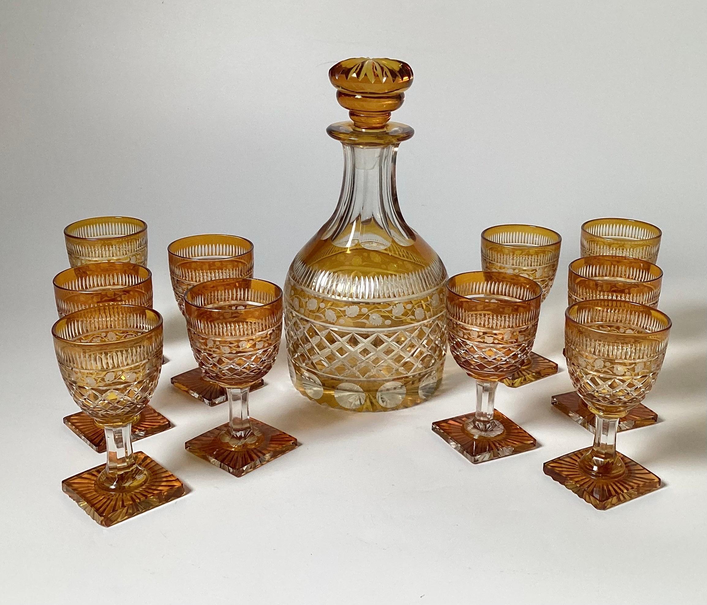 Elegant and rare Amber cut to clear hand blown and hand cut bulbous decanter with 10 wine stems. The decanter with a wide bulbous shape and original stopper, the glasses are also original to the set with the matched pattern of cutting.... The