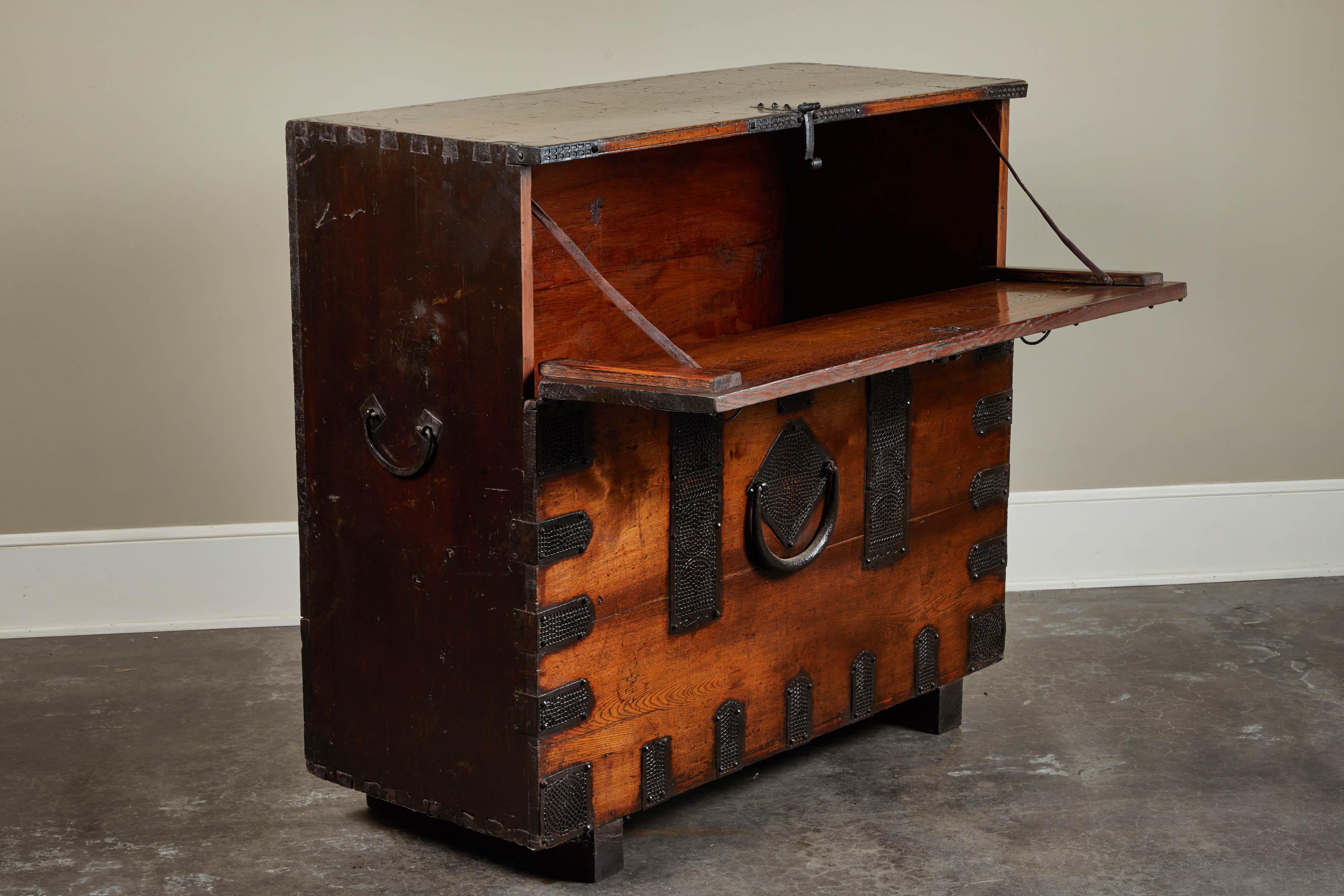 Rare 19th century Korean chest. Unusual size makes chest a rare piece. Beautiful iron hardware decorate the face and lid of the chest. One of two, not quite a pair. Sold individually.