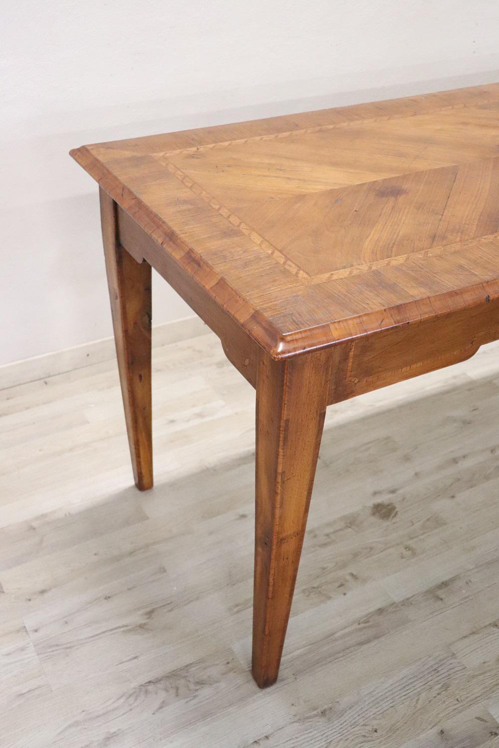 Beautiful important antique long dining room table, 1850s in solid walnut wood. Characterized by a refined inlay work on the top in a geometric style with a central medallion. Very simple and linear, perfect also for a modern environment. This table