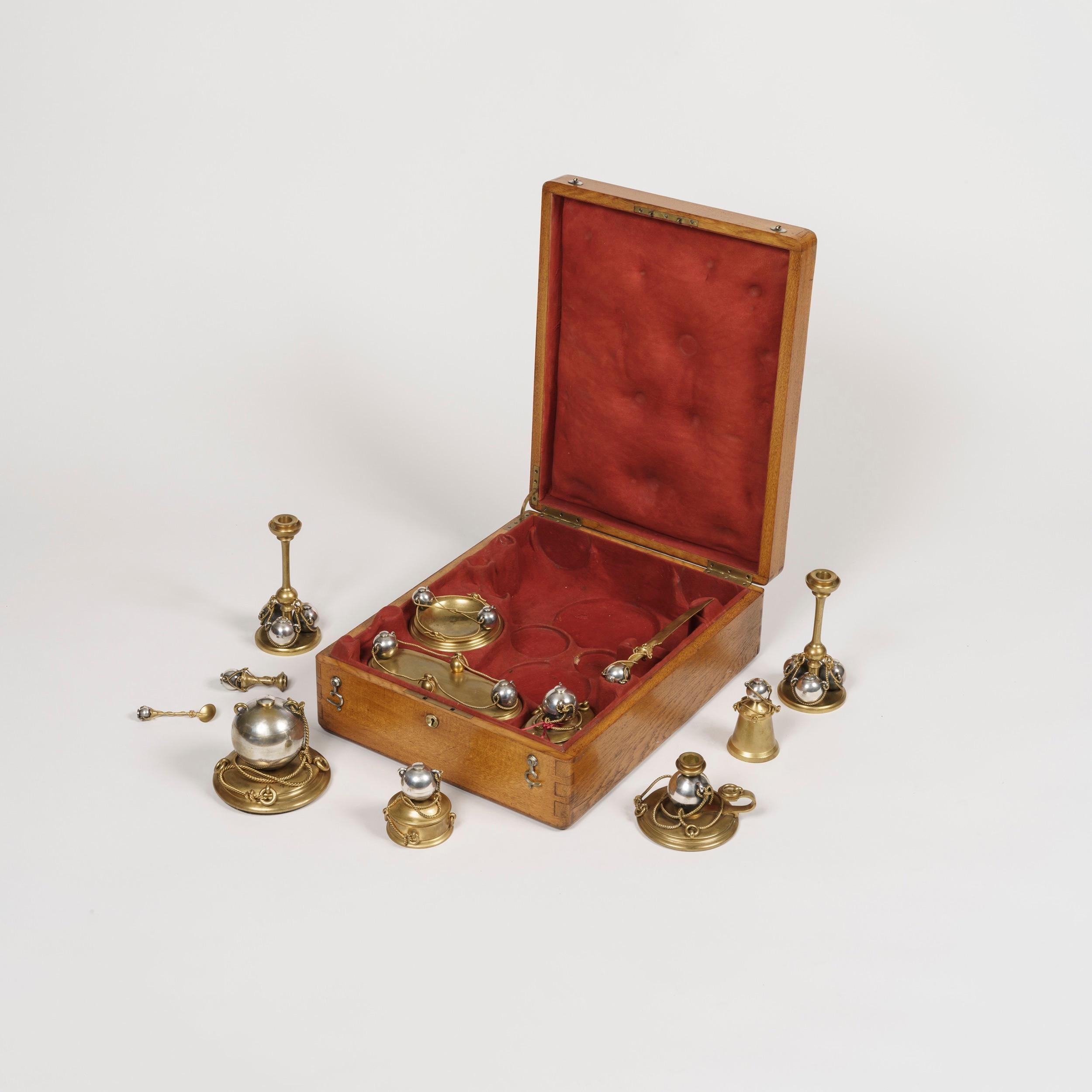A rare nautical desk set

The lockable oak felt-lined case, embossed with the initials 'AL' of the original owner, houses twelve writing implements and accessories, constructed in silver plate and gilt metal, using spheres and chain work