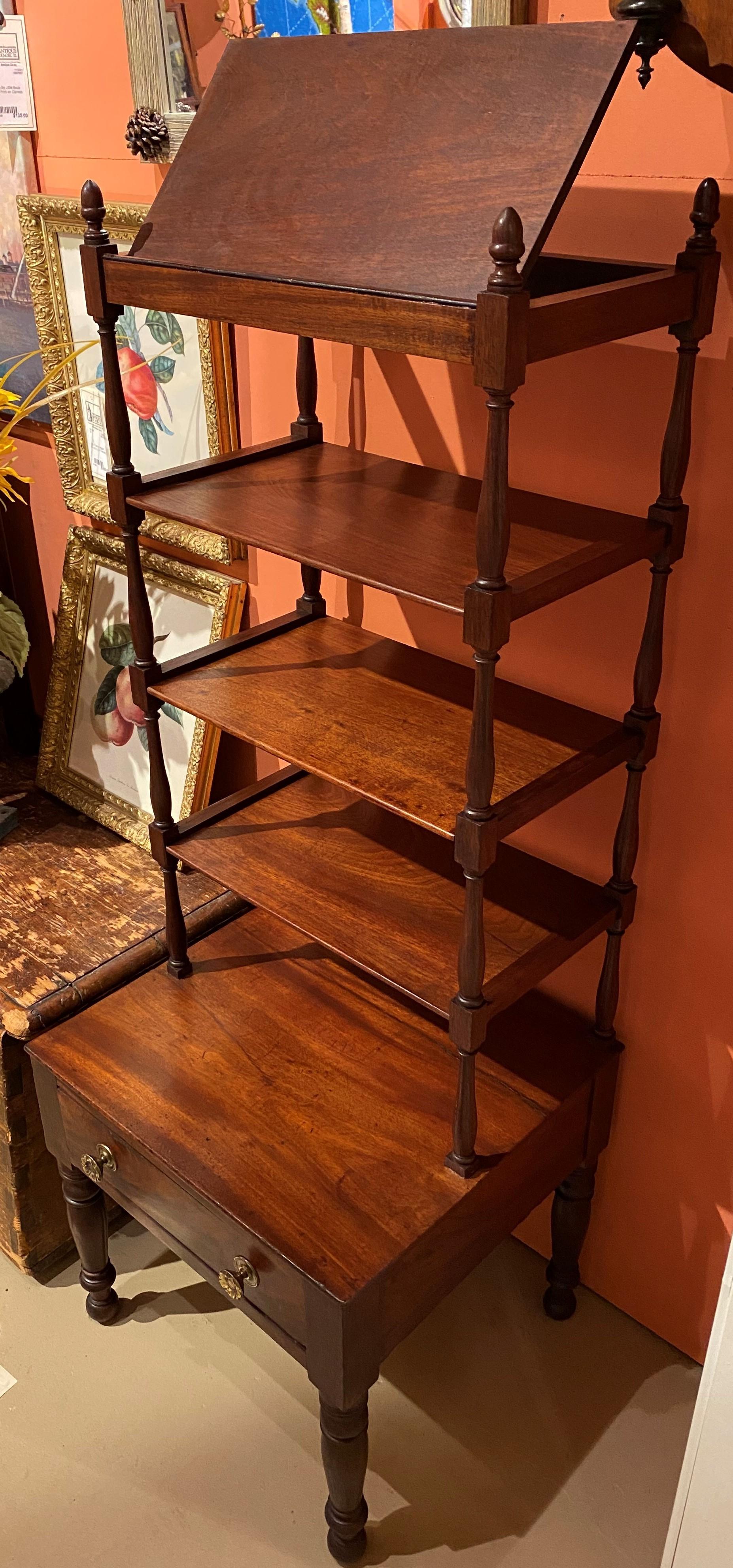 A rare form mahogany one drawer four shelf étagère with hinged top shelf for displaying books, prints or photographs, reverse acorn finials, nicely turned shelf supports, punched brass pulls, and turned legs. Probably New York in origin, dating to