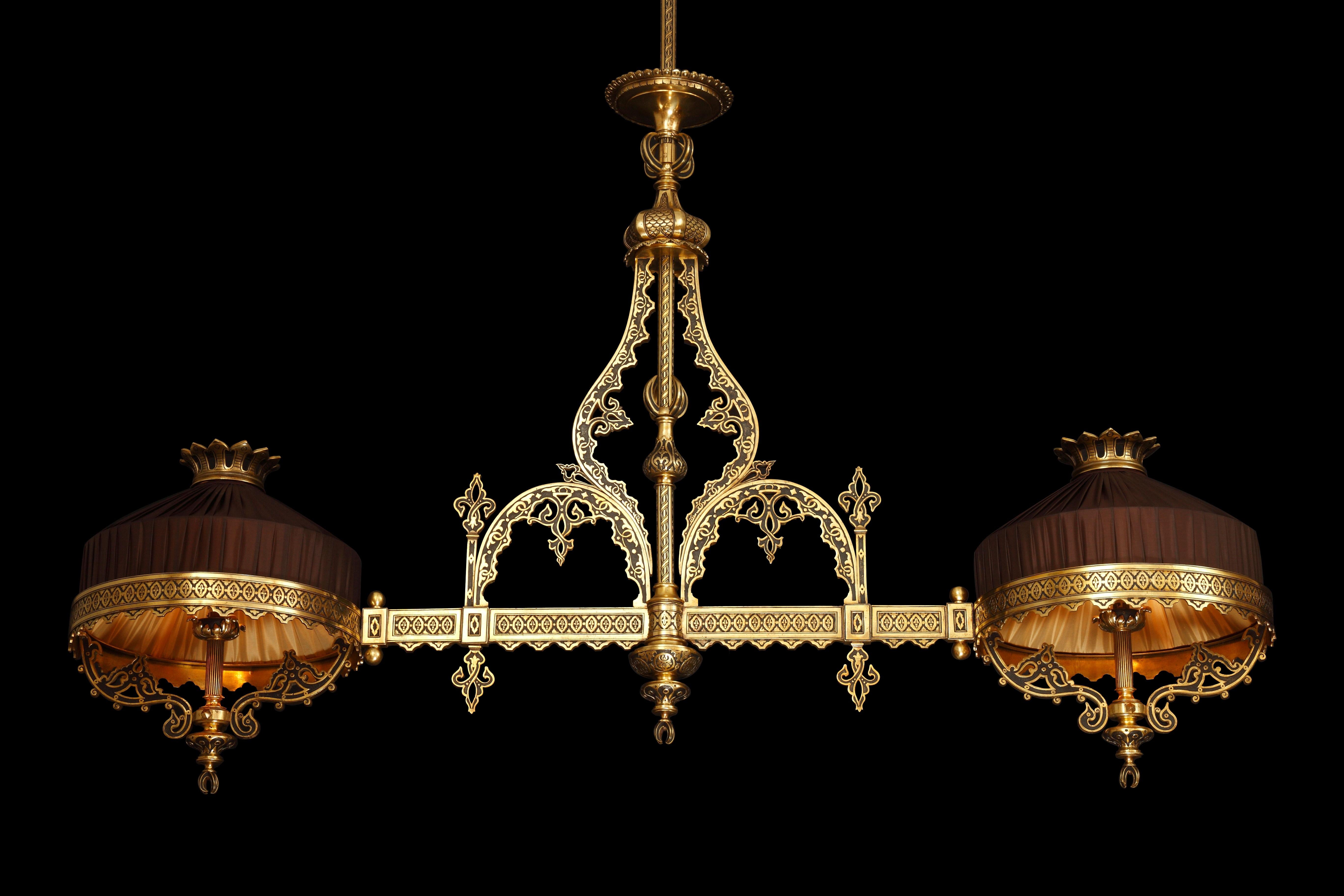 Large elongated Ottoman style chandelier with two lights, in bronze with double patina. The shaft is embellished with multi-lobed openwork arches evoking Moorish architecture, and adorned with stylized patterns covering the entire chandelier. It is