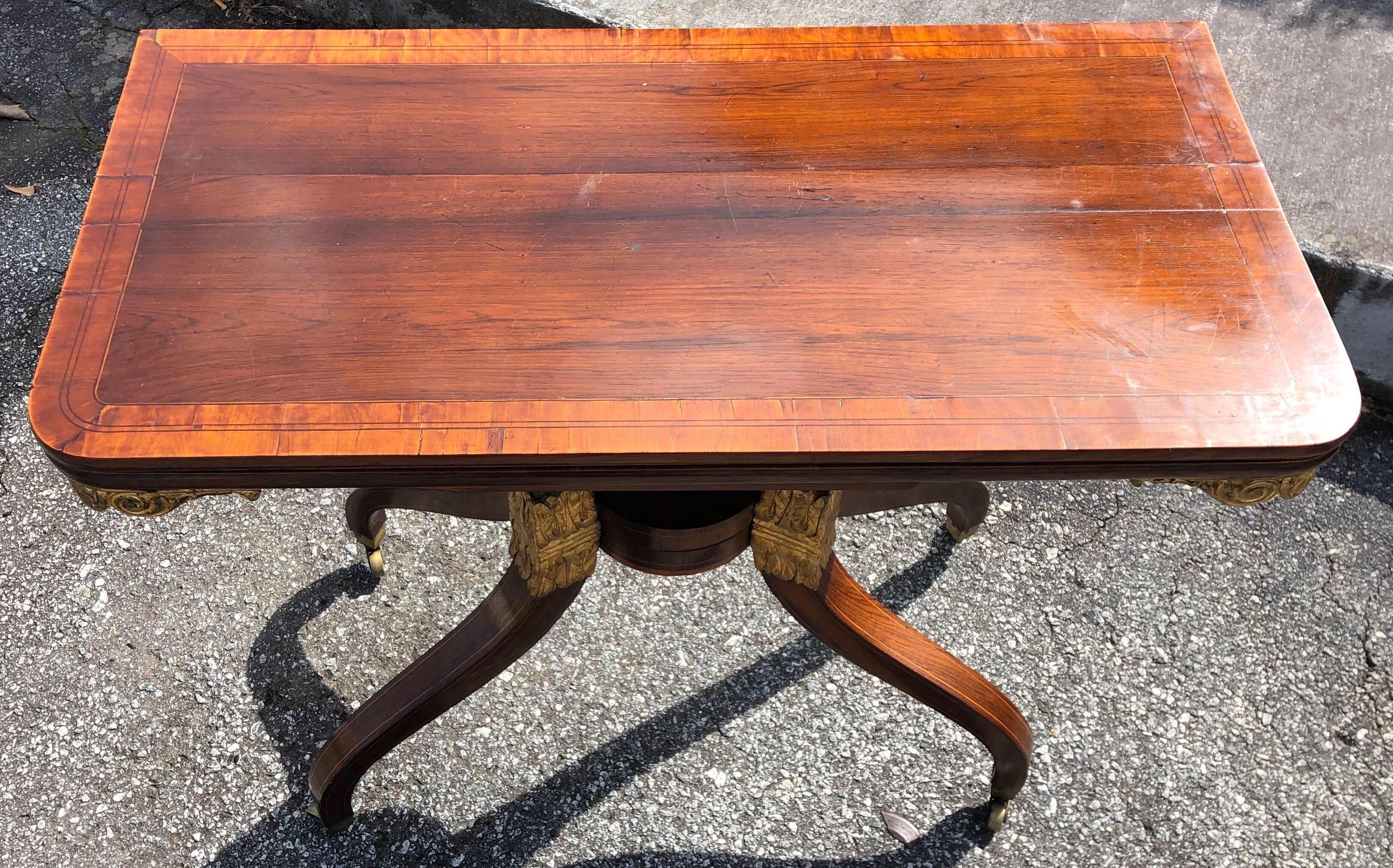Superb quality Regency rosewood Georgian card table. Rare design with a Wilkinson patent action opening mechanism. The back two inverted sabre legs open up in a scissor like fashion from the central circular boss where the other two legs meet.