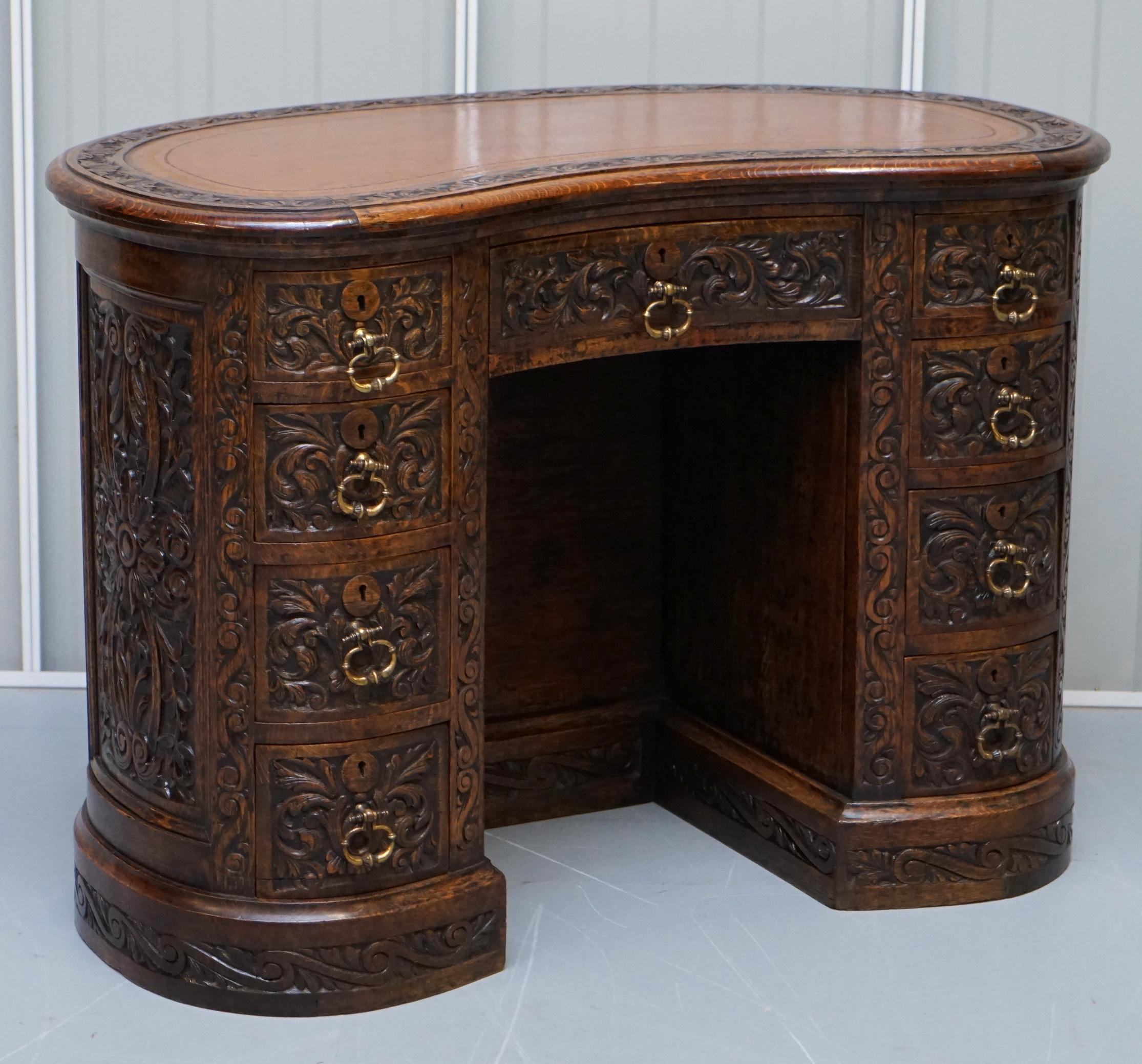 We are delighted to offer for sale this stunning fully restored circa 1860 Gothic revival English oak kidney desk with brown leather top

A very rare find, kidney desks are highly sort after, to find one with the fully carved back is uncommon.
