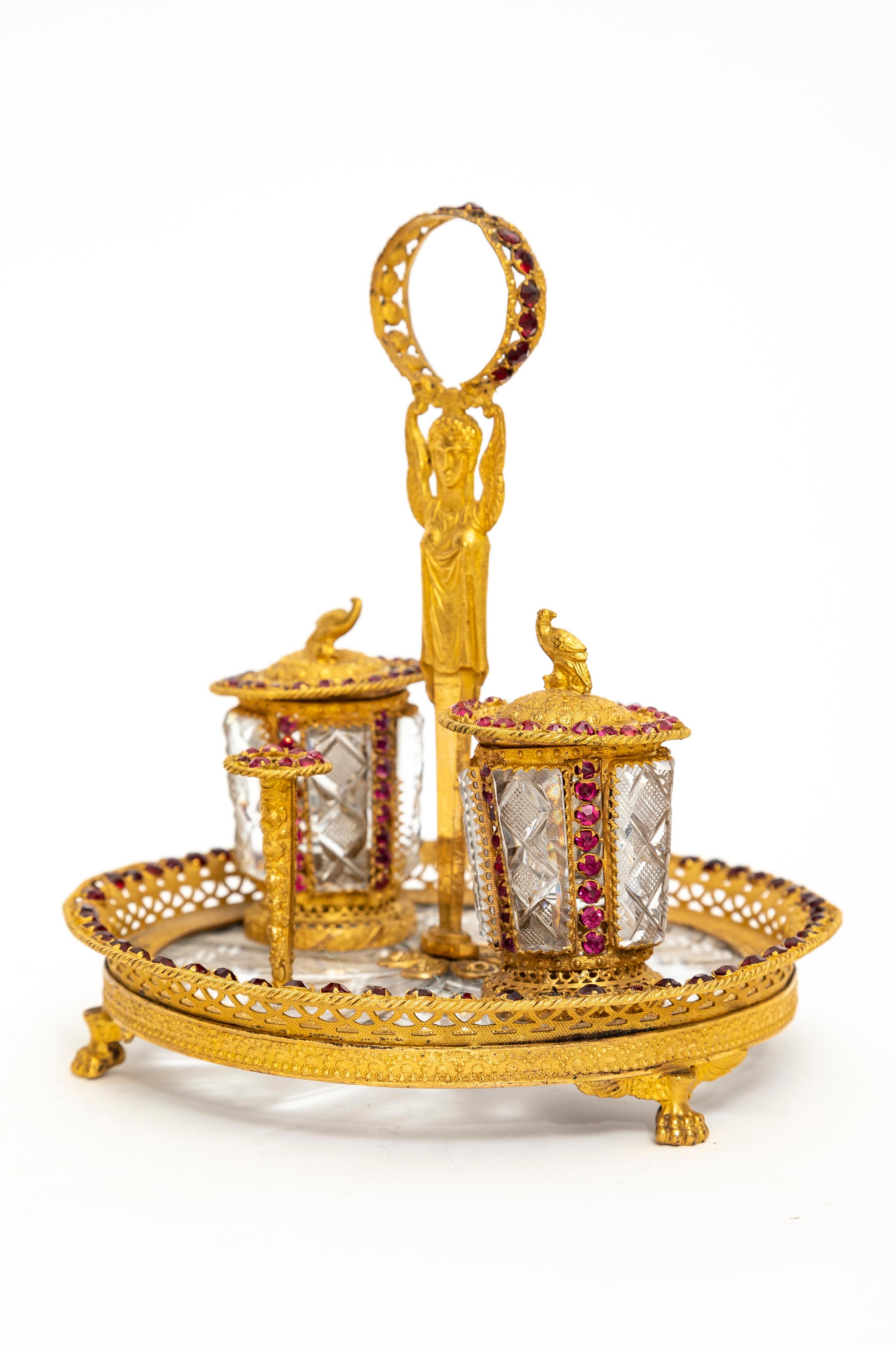 An Extremely Rare 19th Century Russian Empire Ormolu, Hand-Diamond Cut Crystal and Jeweled Inkwell.  The inkwell features a circular base with a faceted crystal insert, framed by an openwork ormolu gallery with a repeating pattern of alternating