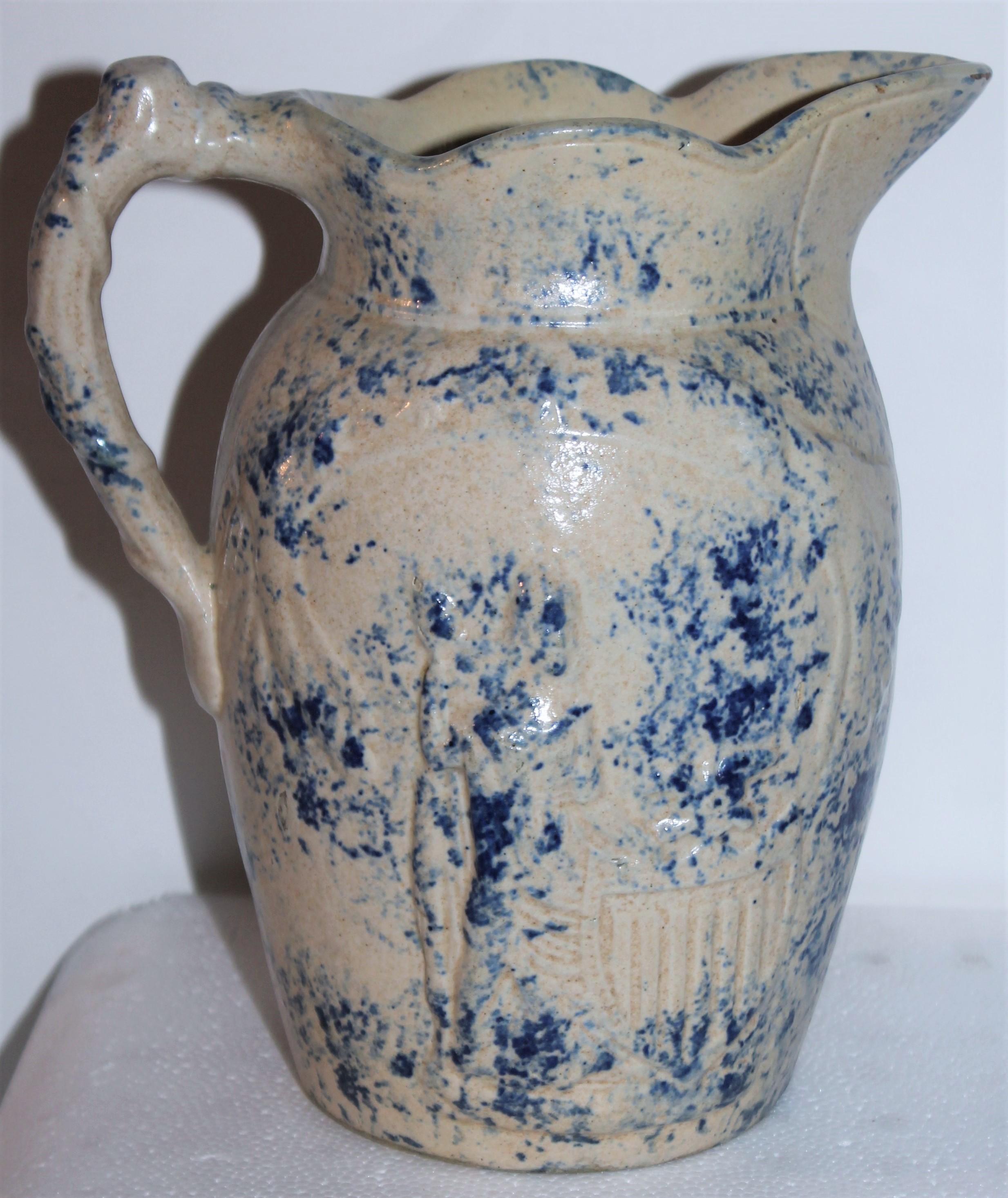 This fantastic rare lady liberty and shield embossed sponge pottery pitcher is in fine as found condition. She is embossed on both sides of the stoneware pitcher. It has a spotted design sponge pattern.