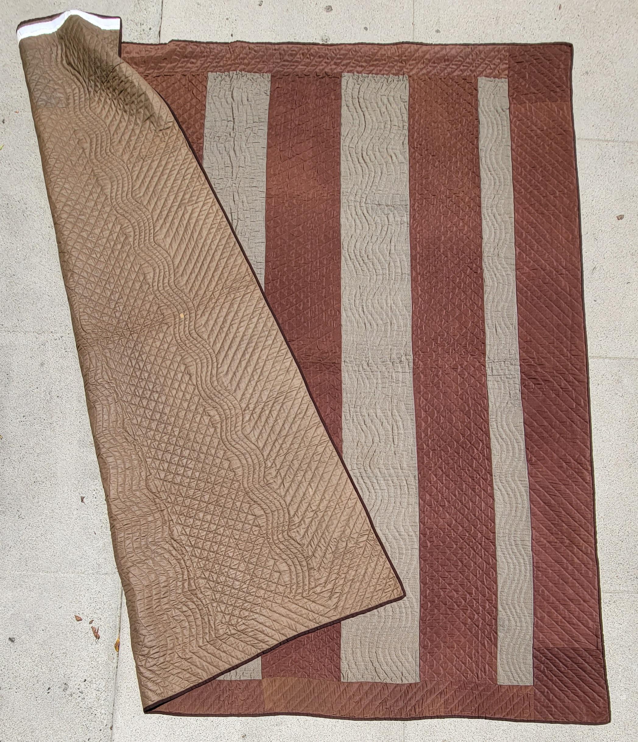 This rare wool split bars quilt is a Quaker quilt from Philadelphia,Pennsylvania and is in pristine condition.The backing is in a fine brown silk in pristine condition.The front of the quilt is in wool and very pristine condition.This quilt comes