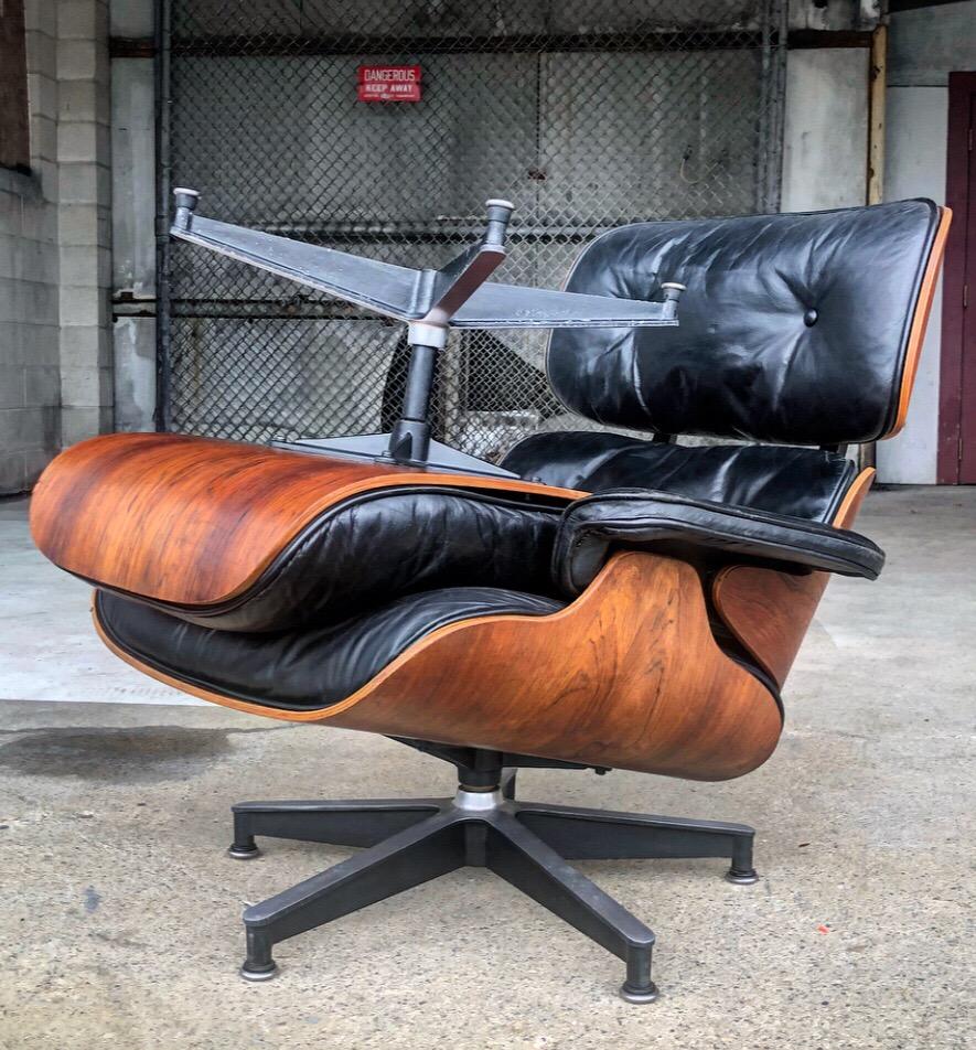 Rare 1956 Eames lounge and ottoman for Herman Miller. This set dates to the first year of production. The ottoman and chair bother rotate on their bases. The rotating ottoman was only produced in the first year that the design was introduced to the