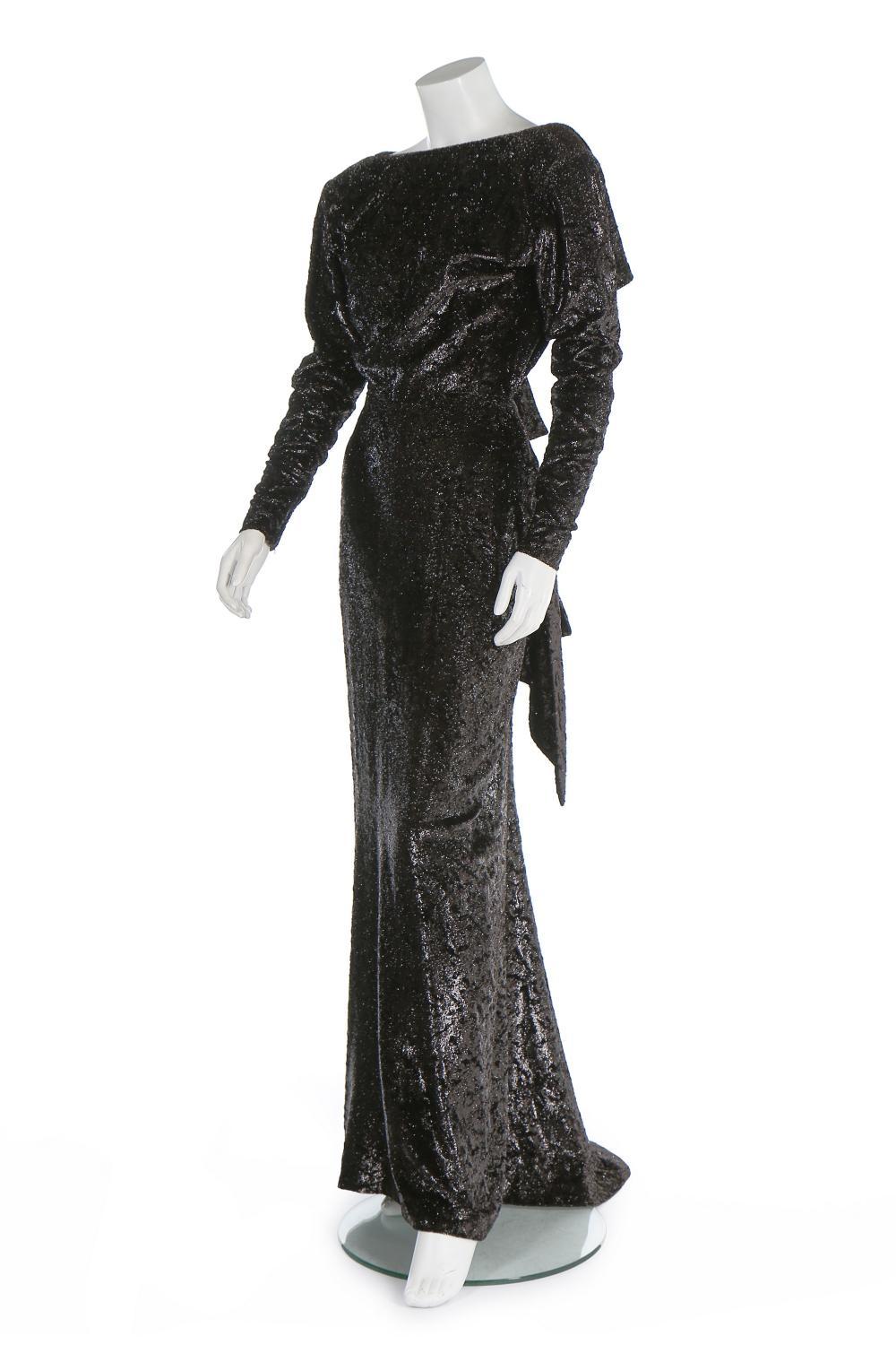 Very Rare 2 in 1 Yves Saint Laurent Haute Couture Twinkly Anthracite Dress Gown
C. 1986, Label N - 60253
Can be Used in 2 Different Ways Because of Snaps
Crushed Twinkly Anthracite Velvet with Animal Print, Cut-Out Details, Open Back, 3D Flower, Zip