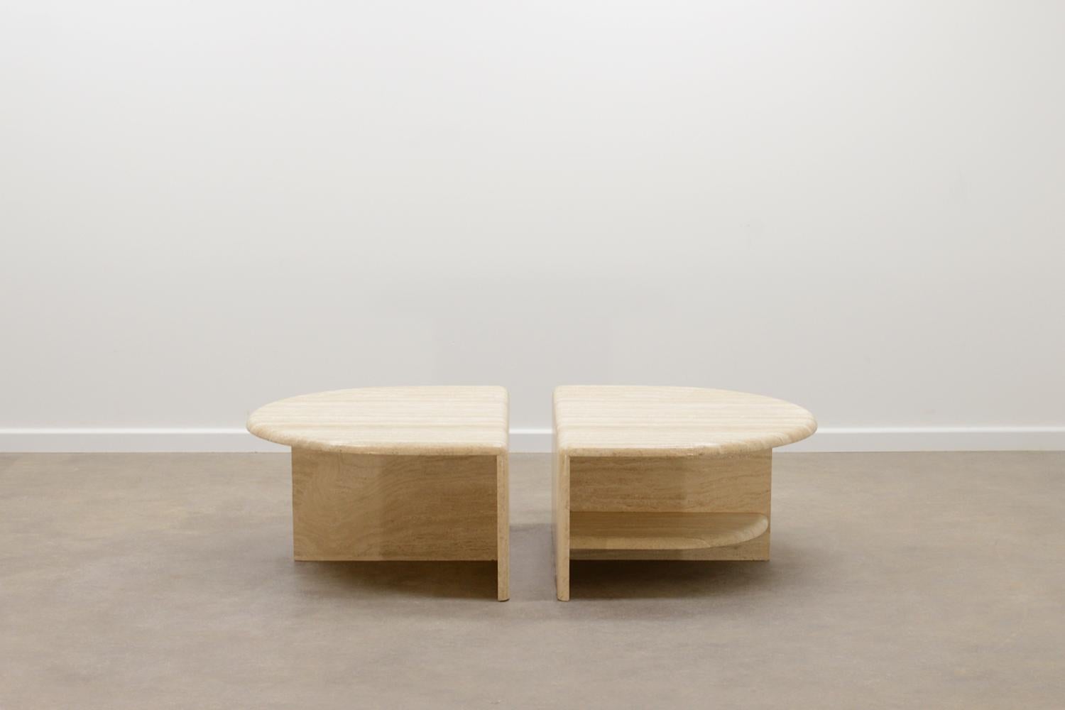 Rare 2 piece Italian travertine coffee table, 70s. Made of solid travertine. Both pieces have a shelf at one side. In very good vintage condition. 

 