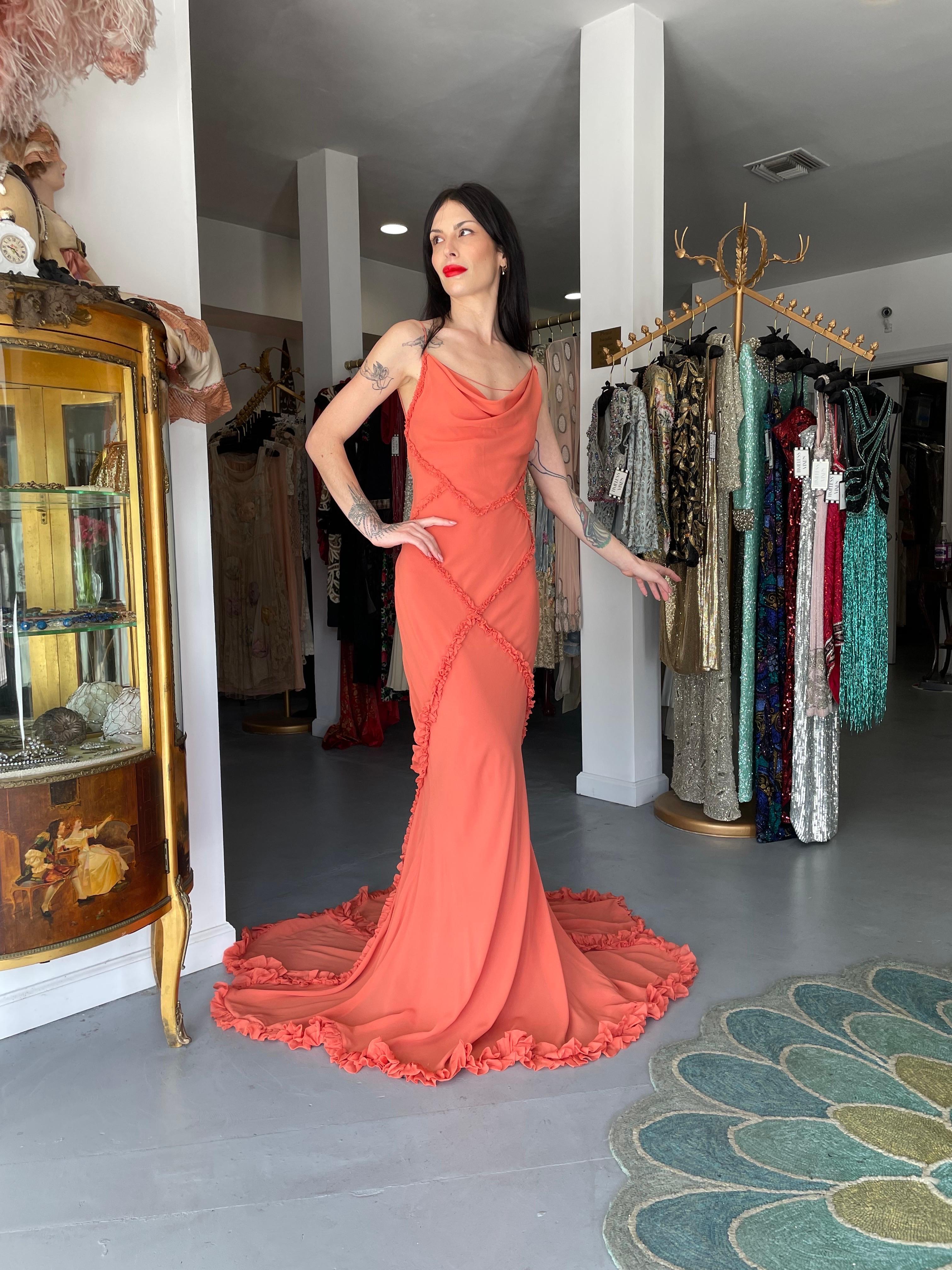 An absolutely sensational and highly coveted John Galliano vibrant coral pink silk chiffon bias-cut trained gown dating back to his 2008 spring/summer collection. These early examples of his work are very collectable and are becoming incredibly hard