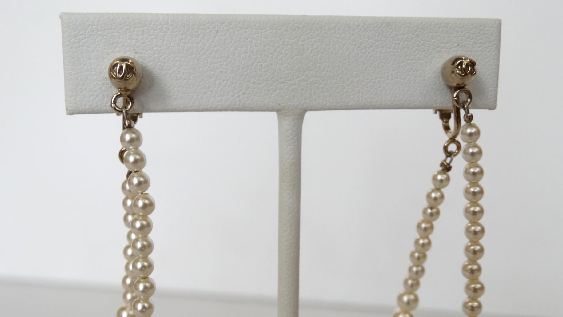 Who Doesn't Want To Be Dripping In Pearls? Especially Chanel! These adorable Chanel Pearl drop hoop earrings are from their 2014 Fall collection. Featuring a rounded circular strand of pearls which increase in size throughout the hooped strand. The