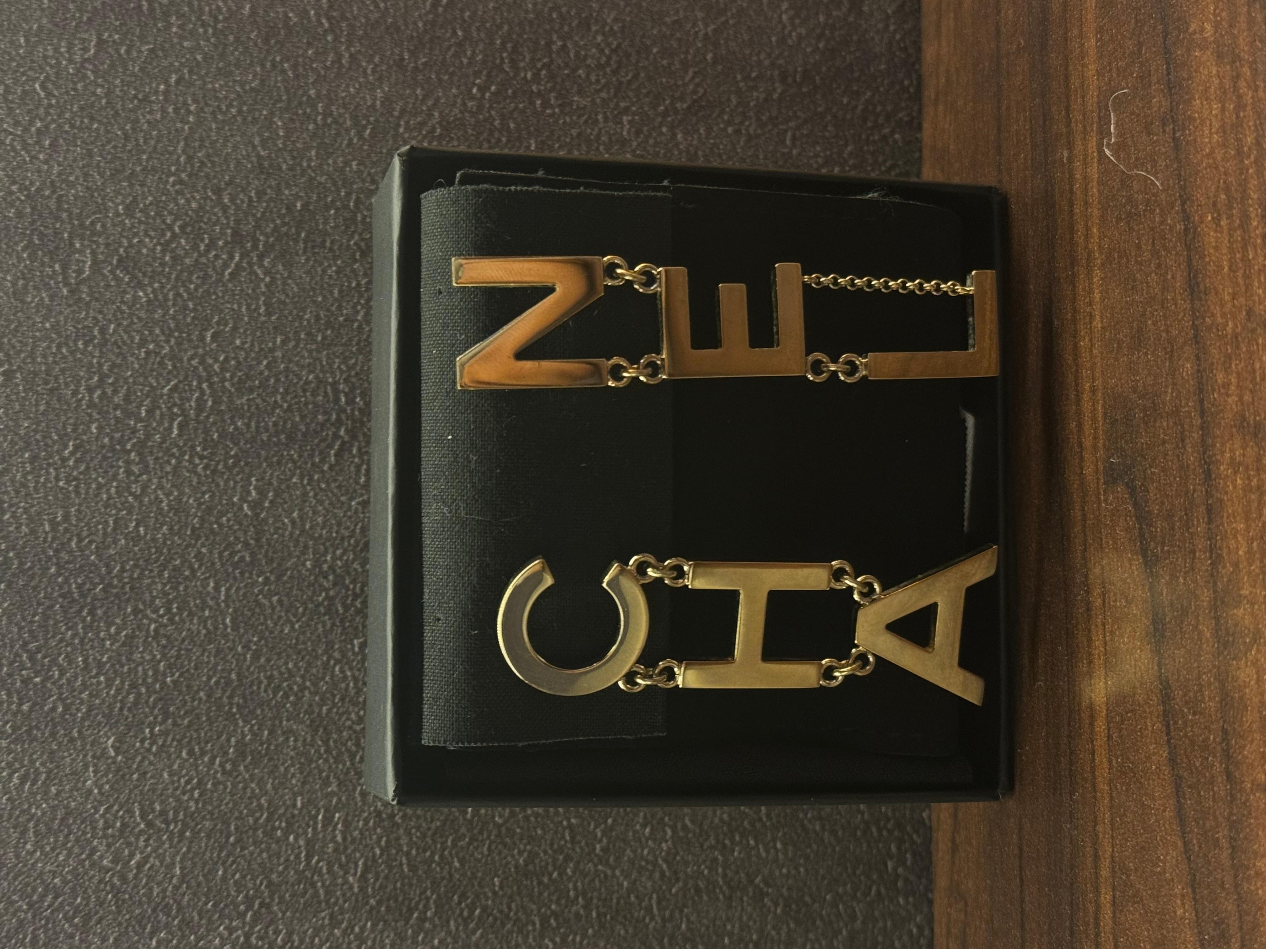 Iconic chanel lettering drop earrings. Beautiful statement piece. Easy to pair with anything. Comes with its box and ribbon. Minor scuffing on the hardware throughout. Light gold.