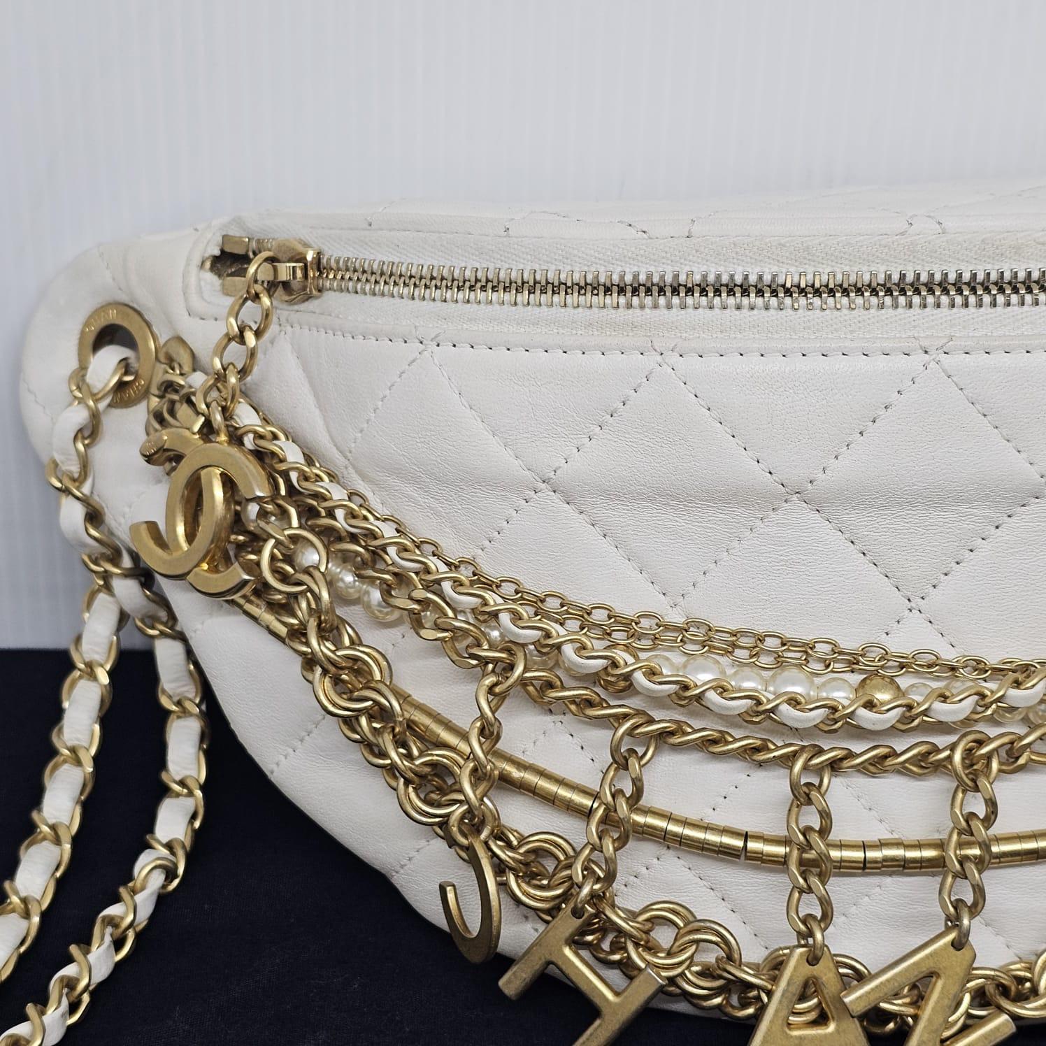 Rare Chanel all about chains bumbag in white leather. Slight dirt marks due to usage. Minor scuffing on the hardware details. Series #28. Comes with its holo, card and dust bag.