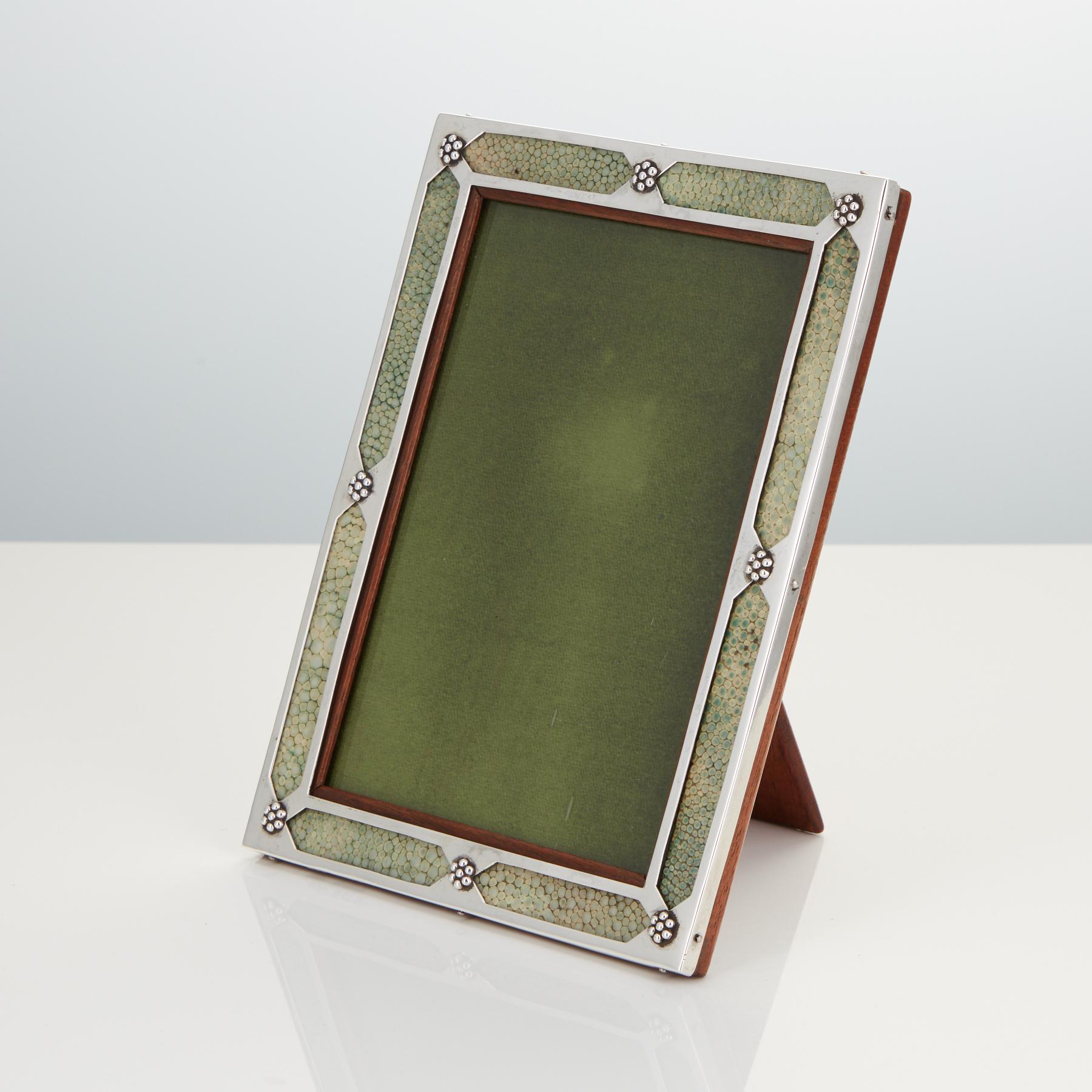 Rare 20th century Art Nouveau sterling silver and shagreen photograph frame dated Birmingham, 1908.
The maker is Liberty & Co.
This piece is by a great original condition including the back. It has elements of Arts & Crafts in the silver