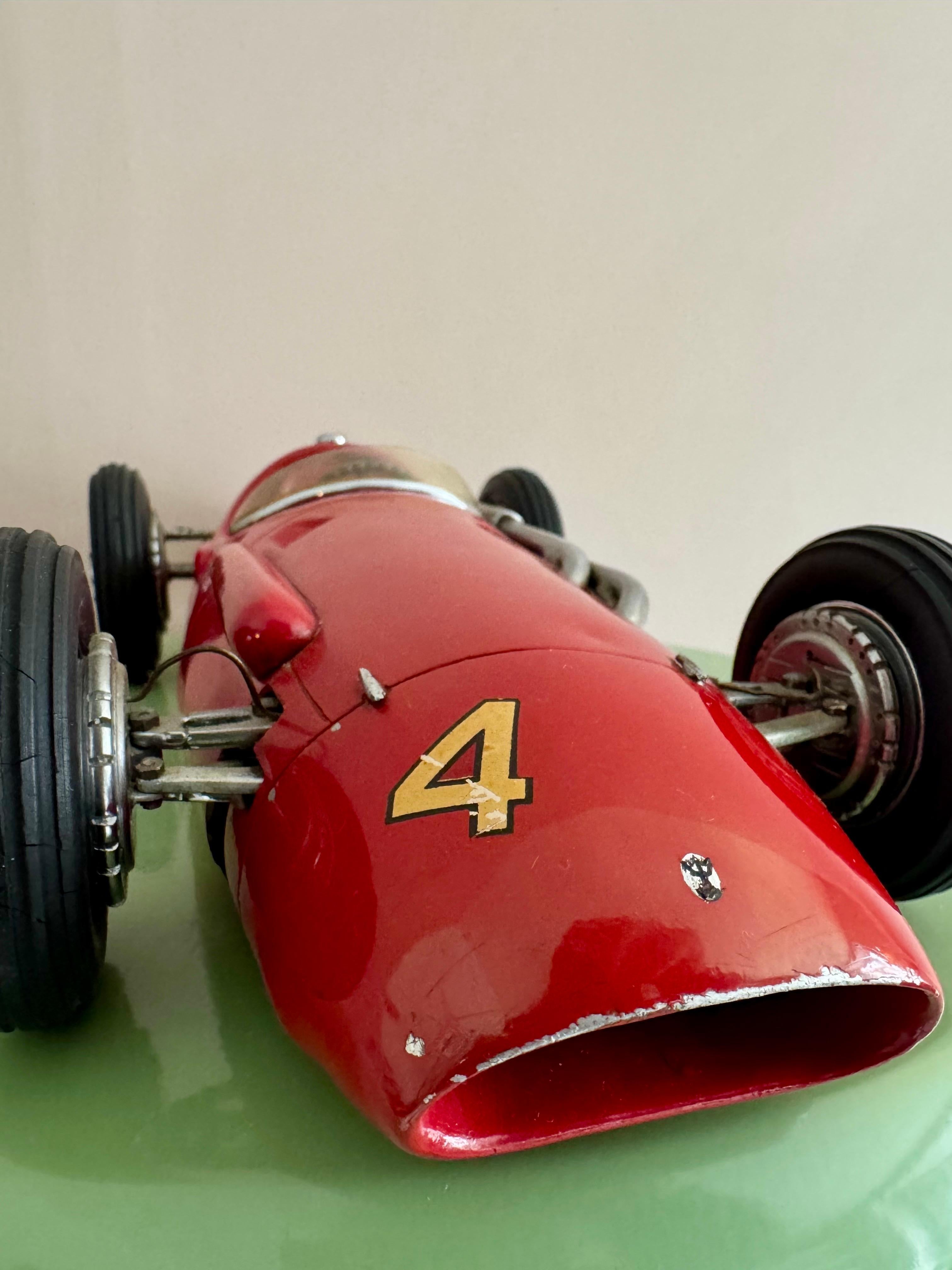 A superb 1:12 scale scratch-built model of the Maserati 250F, handcrafted by the renowned model maker Michele Conti. This exquisite kerbside model, produced in the mid 1950s, is among the most beautiful and highly sought-after examples of Conti’s