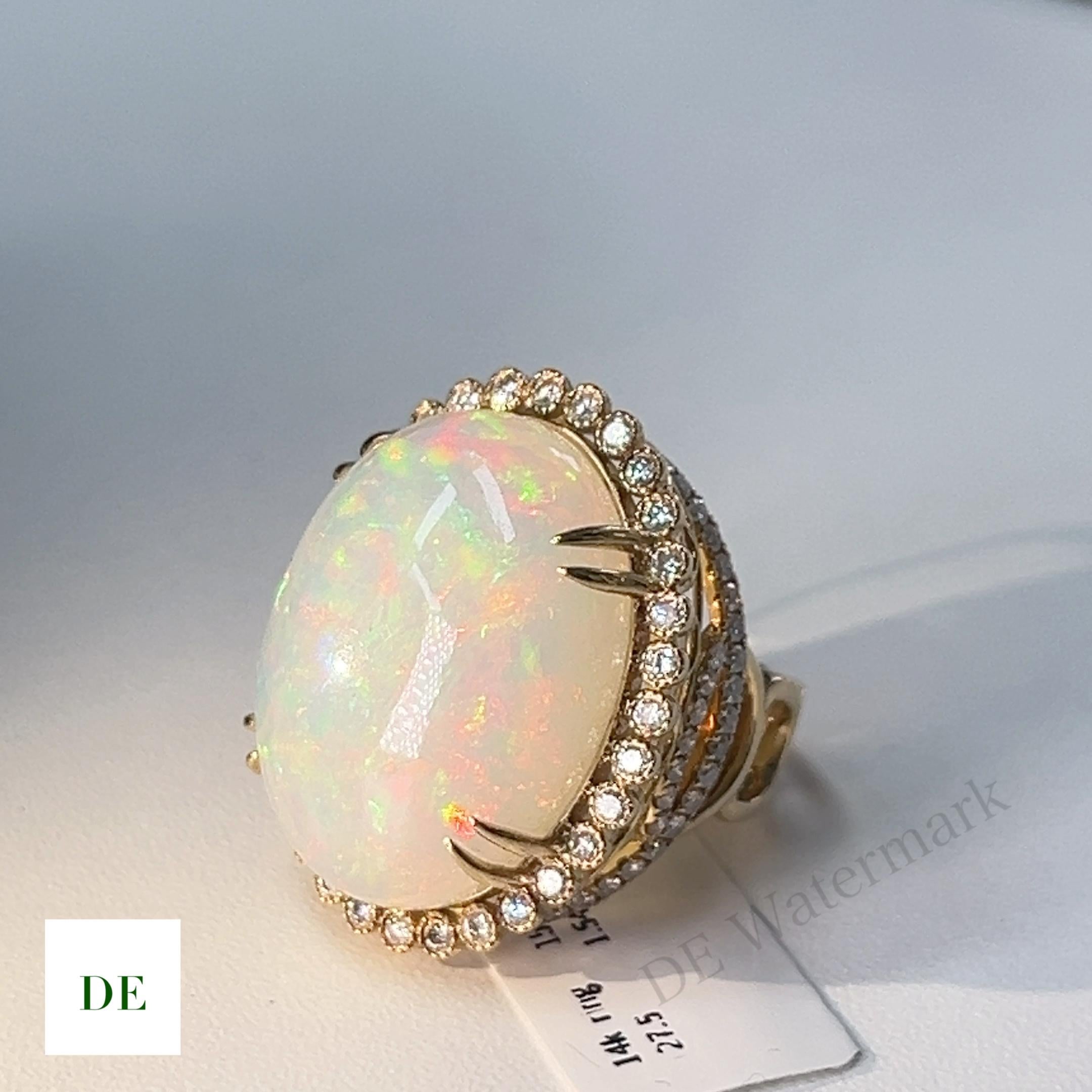 This opal and diamond ring is a rare and unique piece of jewelry that is sure to capture your heart. The centerpiece of the ring is a natural opal that weighs an impressive 27.5 carats. The opal's play of color is breathtaking, showing a range of