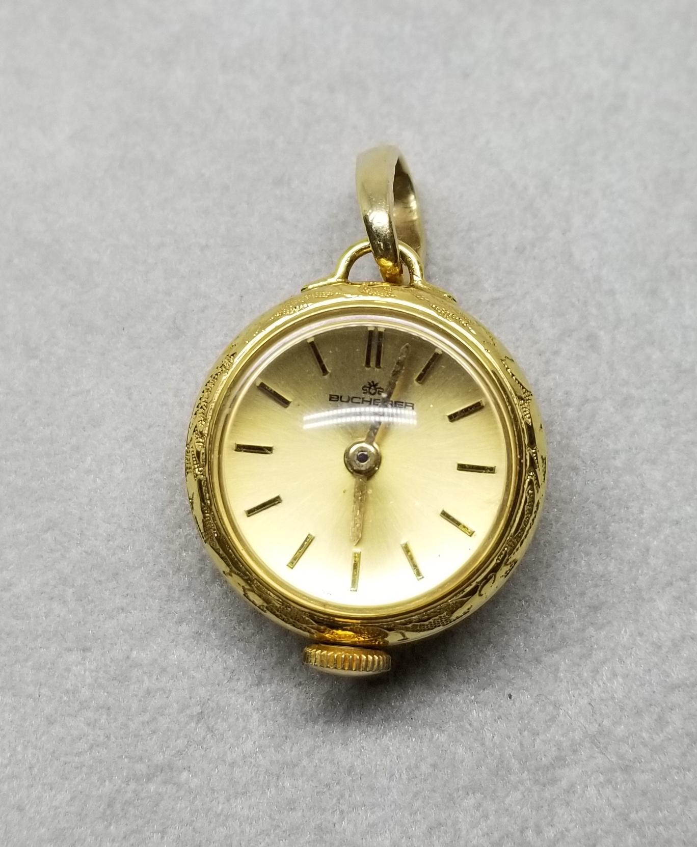 Rare 3/4 inch Vintage 14k yellow gold Bucherer 17 Jewel Swiss Pendant Watch  Fob Round Shape, in good working condition with skeleton back.