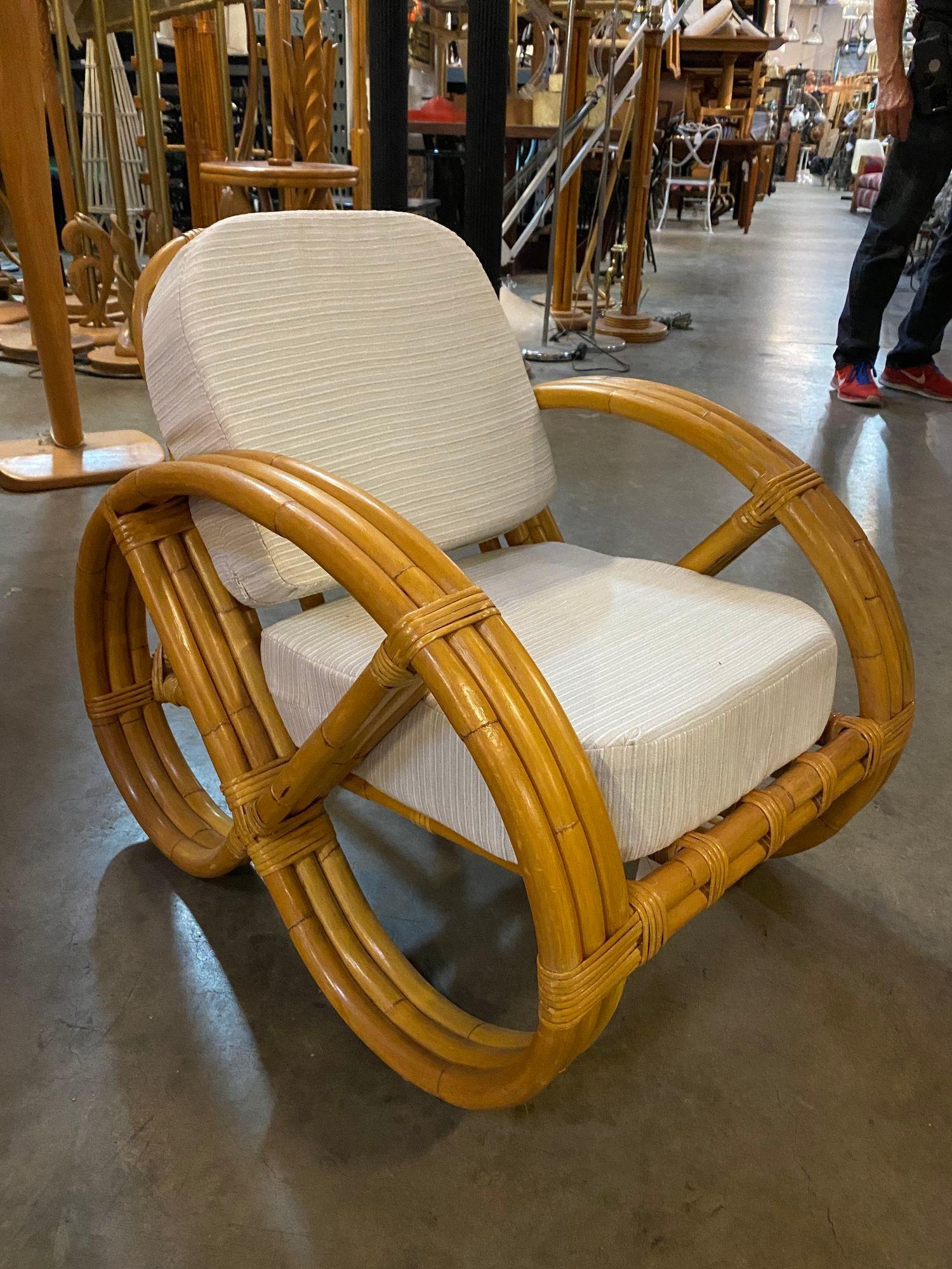 Rare three-strand round full pretzel arm rattan living room set with a lounge chair and a settee with fancy wicker wrappings. The set features white cloth cushions and 2 throw pillows.


Chairs: 23