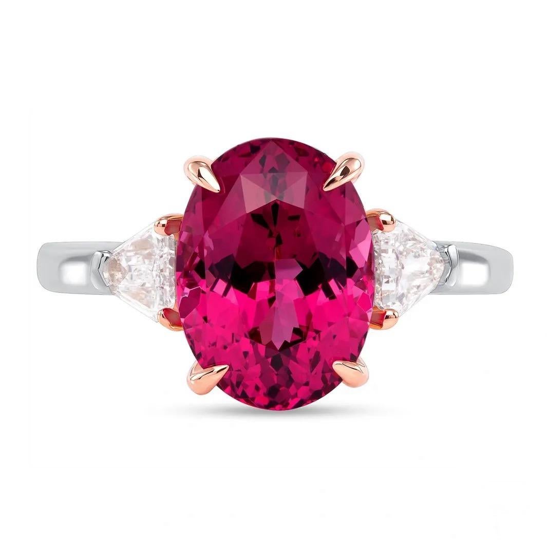 Some spinel colors are more rare and valuable than others.

This heavenly 4.07-carat untreated Mahenge Red Spinel presented here is a great example of a rare gem. It is flanked by two shield-cut diamonds totaling 0.38 carats. The spellbinding spinel