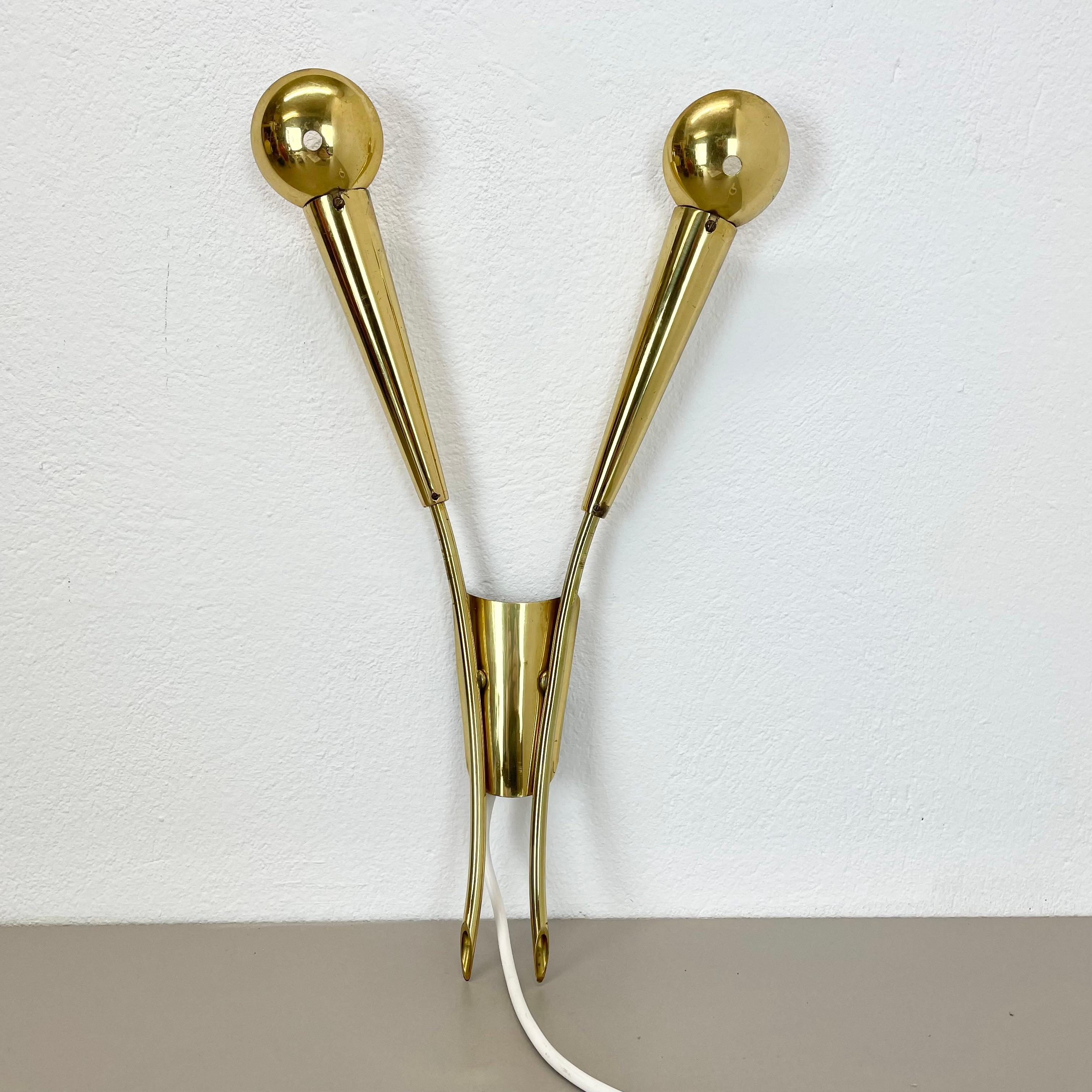Article:

brass theatre wall light sconce



Origin:

Italy



Age:

1950s


This modernist light was produced in Italy in the 1950s in Italy. It is made of brass and metal with little shade elements on the front of the sockets covering the light