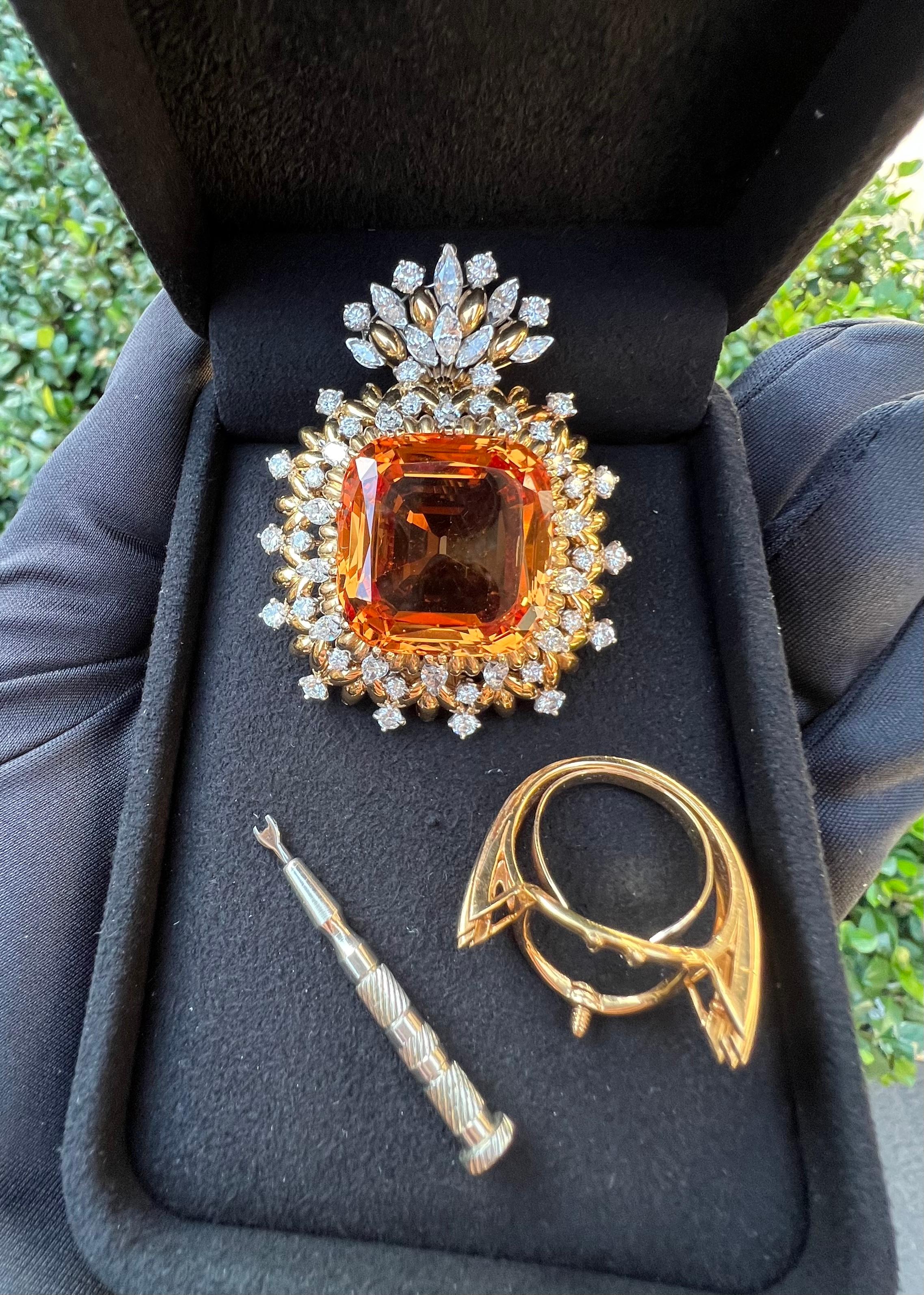 Magnificent, very collectible, huge natural Imperial Precious Topaz and diamond estate pendant, ring, and brooch convertible combination trio is set in 18 karat yellow gold and features in the center one very large modified mixed cushion cut natural